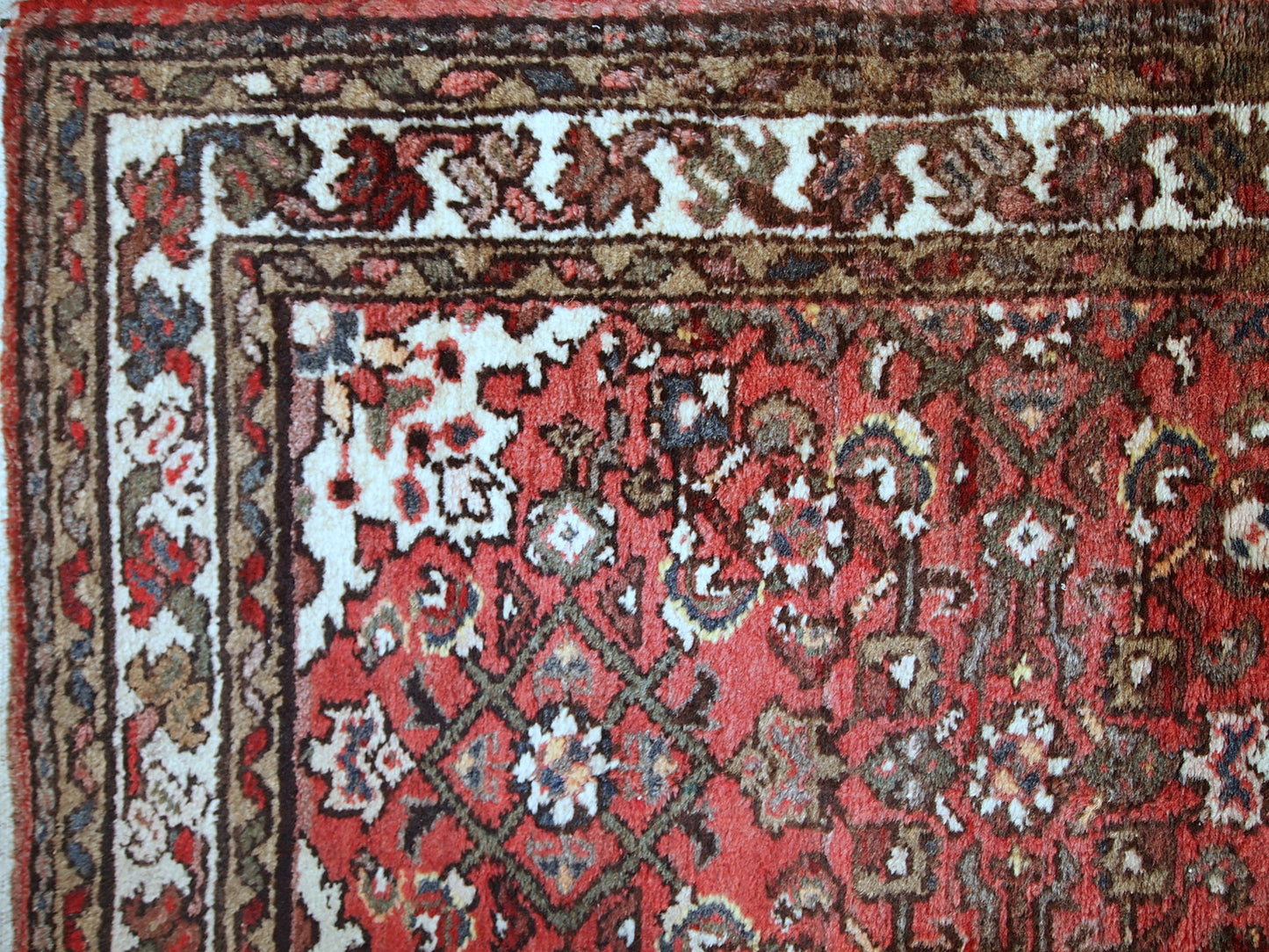 Vintage Persian Hamadan rug in good original condition. The rug is from the middle of 20th century made in red wool.