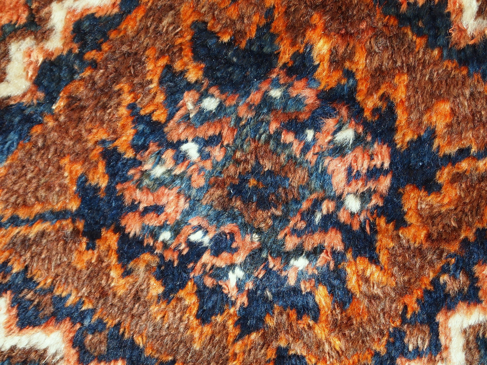 Antique collectible Persian Shiraz rug in original good condition. The rug is in rust shade with navy blue and white details. 