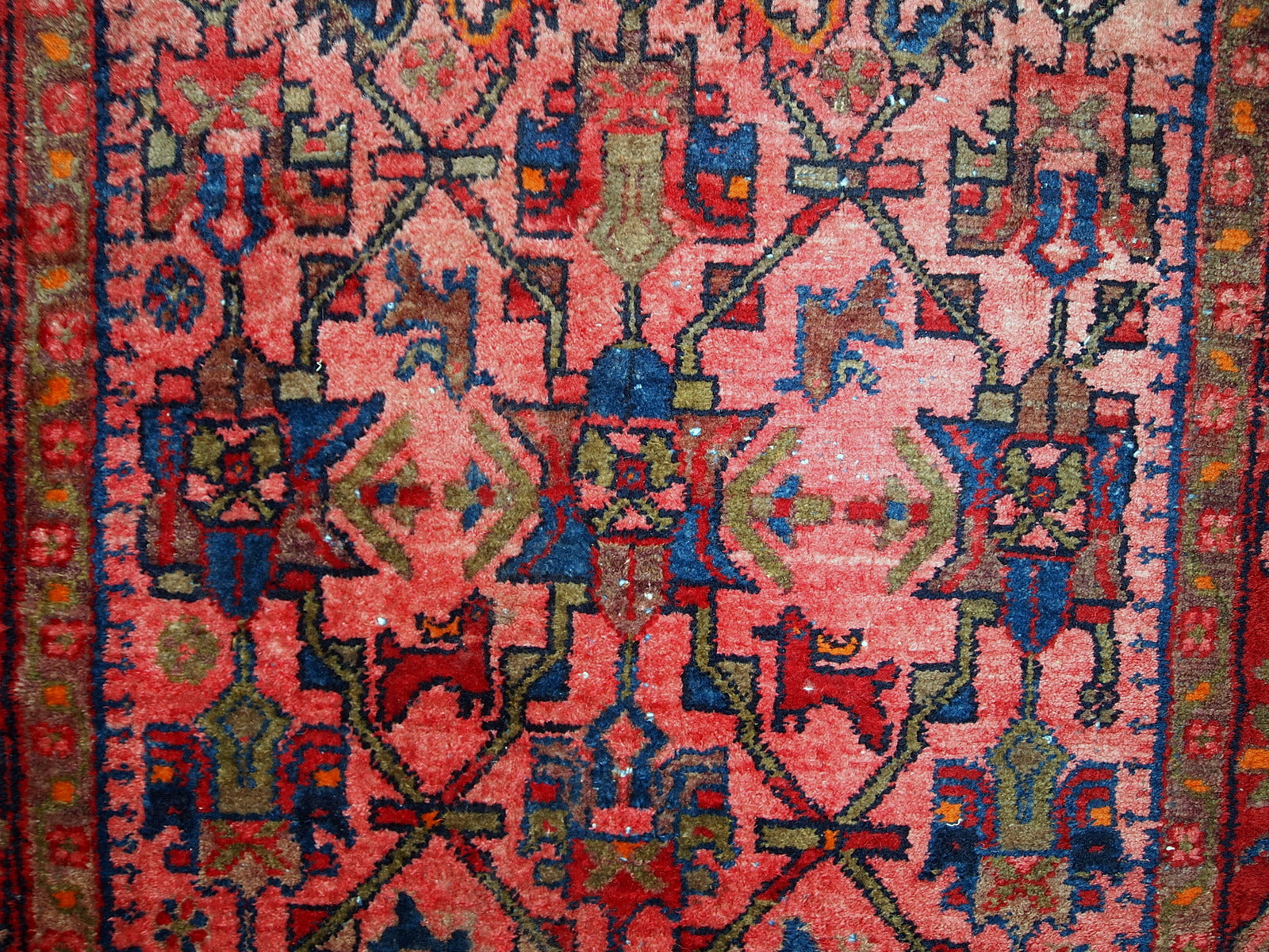Hand made antique Persian Malayer rug in original good condition. The main colors of this rug are variety of red shades. The details of the tribal ornaments on it are in navy blue and olive shades. 