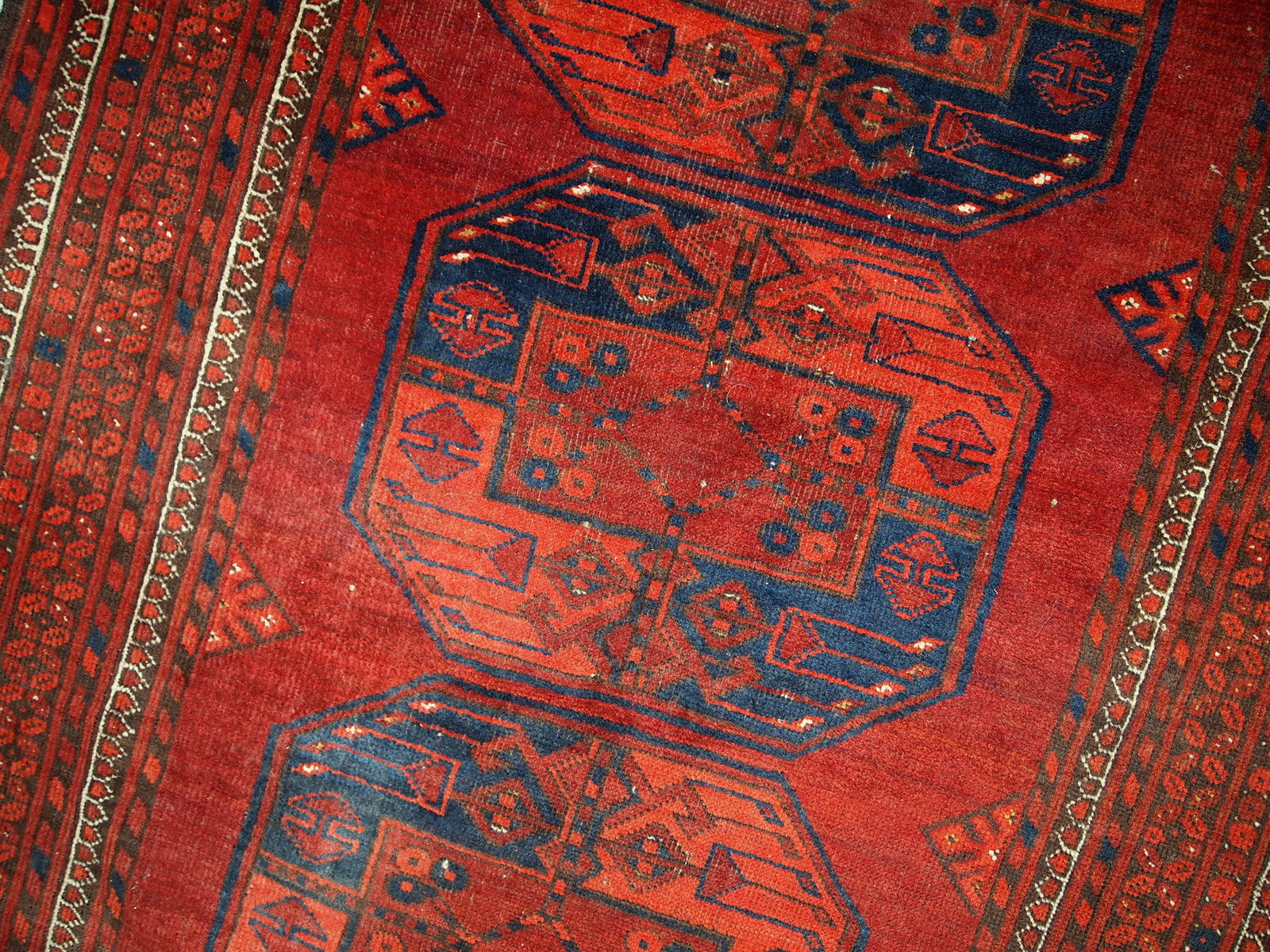 Antique Afghan Ersari rug in original condition, it has some low pile. The rug is from the mid 20th century made in red wool.
