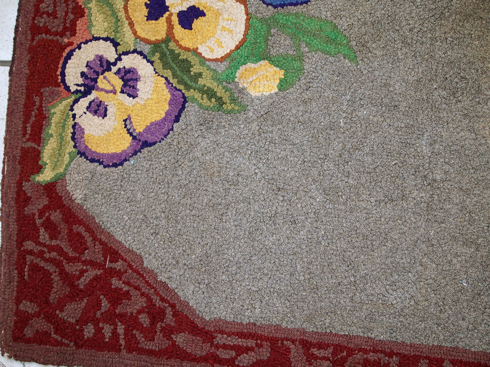 Antique decorative American hooked rug with allover design in grey shade. The condition is original good.