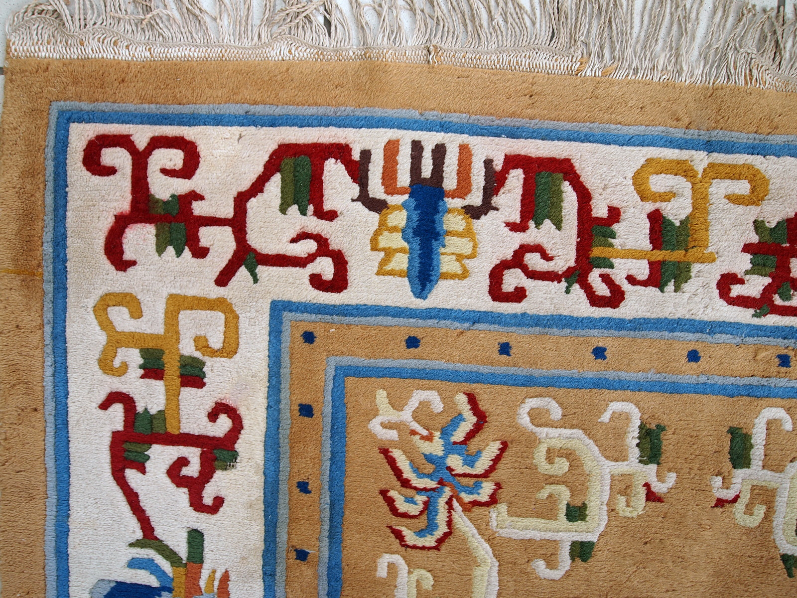 Vintage hand made Art Deco Chinese rug in good condition. Beautiful light brown background decorated with abstract design in burgundy and blue shades. 