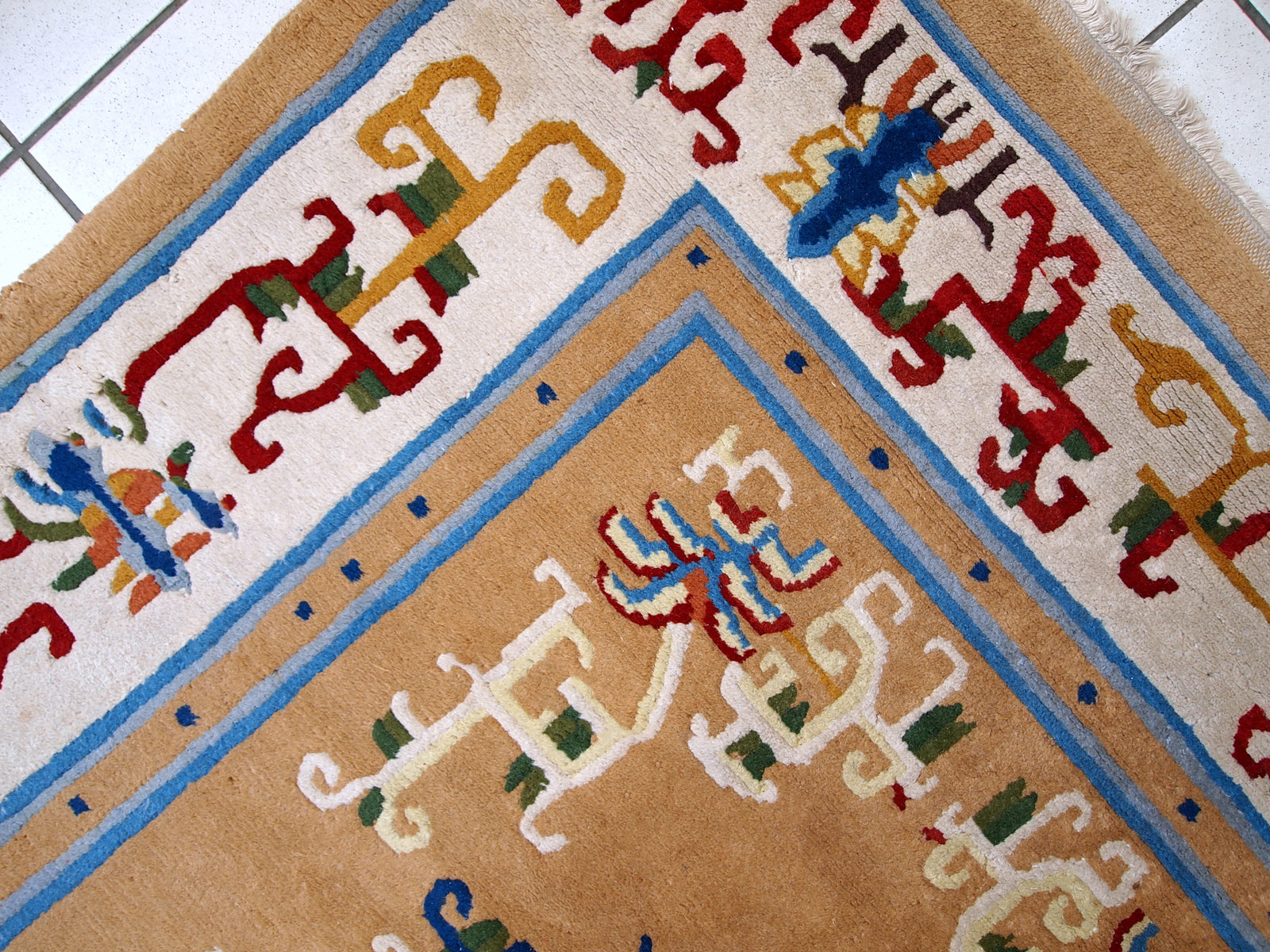 Vintage hand made Art Deco Chinese rug in good condition. Beautiful light brown background decorated with abstract design in burgundy and blue shades. 