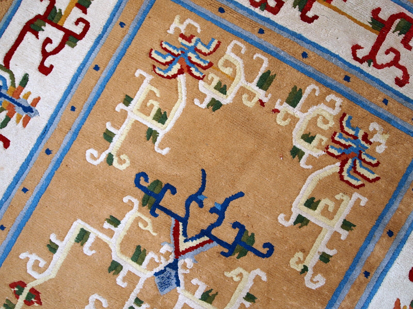 Vintage hand made Art Deco Chinese rug in good condition. Beautiful light brown background decorated with abstract design in burgundy and blue shades. 