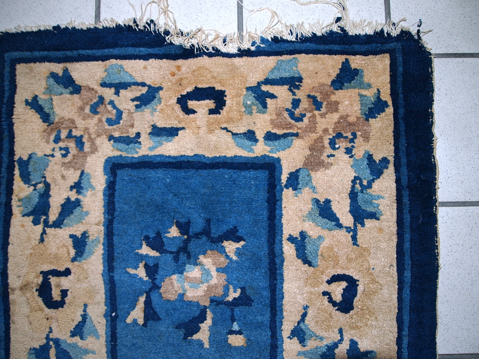 Detailed view of the rug's intricate design in navy blue and beige