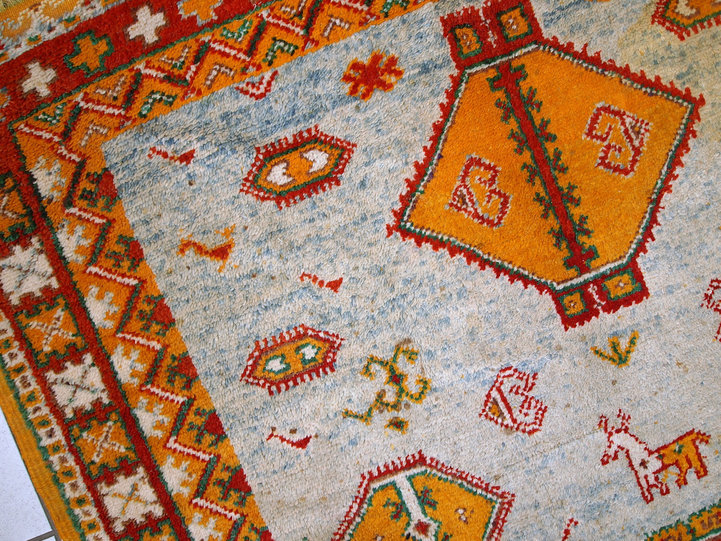 Antique hand made Moroccan rug in original condition, it has some age discolorations and some low pile. The rug is in sky blue color with tribal design, made in the beginning of 20th century in Morocco.