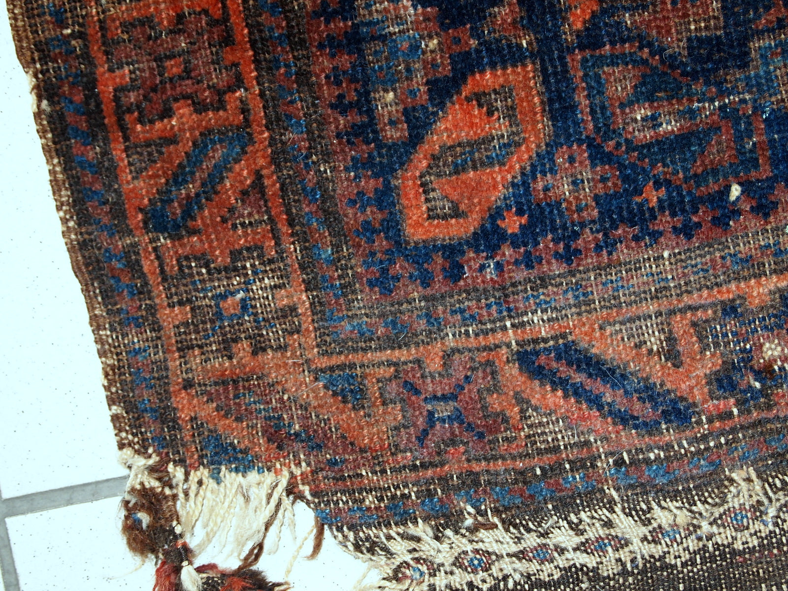 Collectible Afghan Baluch bagface in distressed condition. The rug has been made in the end of 19th century in Afghanistan.
