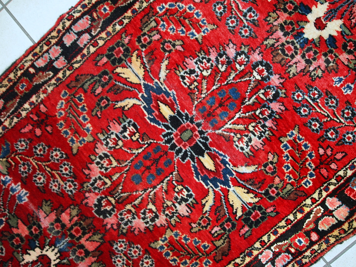 Hand made antique Persian Lilihan runner in original condition, it has several areas with low pile. This runner is heavy, it has been made in the beginning of 20th century.