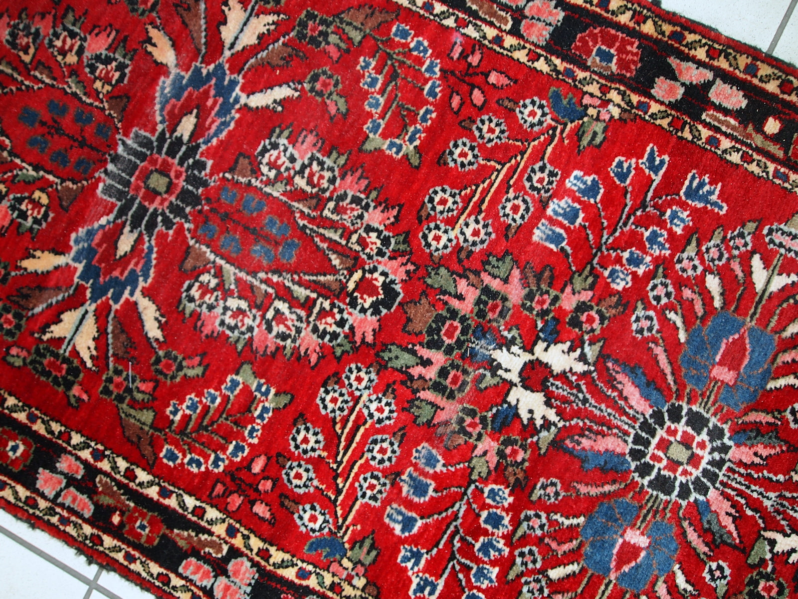 Hand made antique Persian Lilihan runner in original condition, it has several areas with low pile. This runner is heavy, it has been made in the beginning of 20th century.