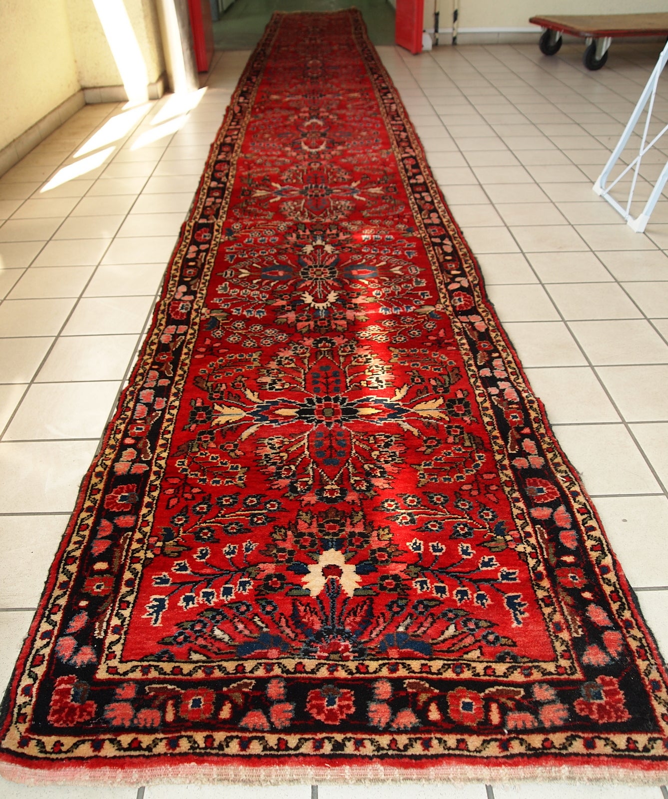 Hand made antique Persian Lilihan runner in original condition, it has several areas with low pile. This runner is heavy, it has been made in the beginning of 20th century.