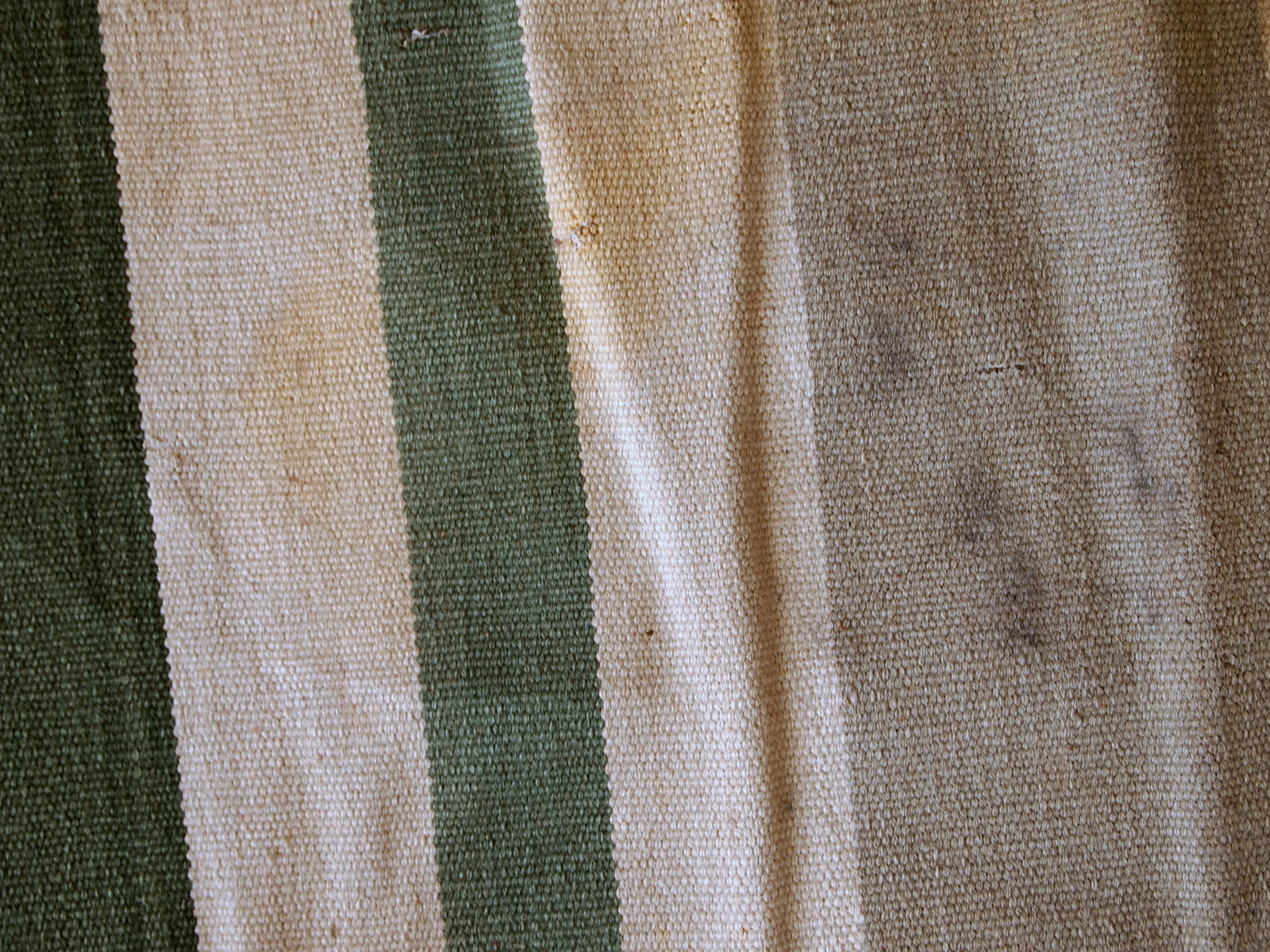 This kilim has very simple stripes motive in dark green, white and grey shades. It is in original condition from the beginning of 20th century, has some stains.