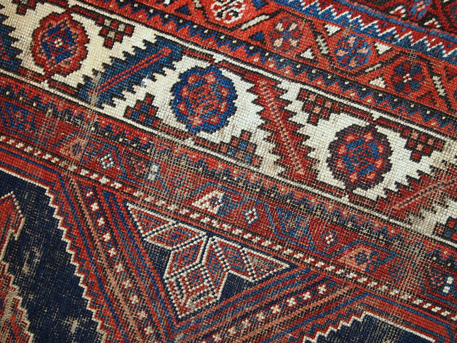 Antique Persian Shiraz rug in distressed condition. The rug made in traditional tribal design in the beginning of 20th century.