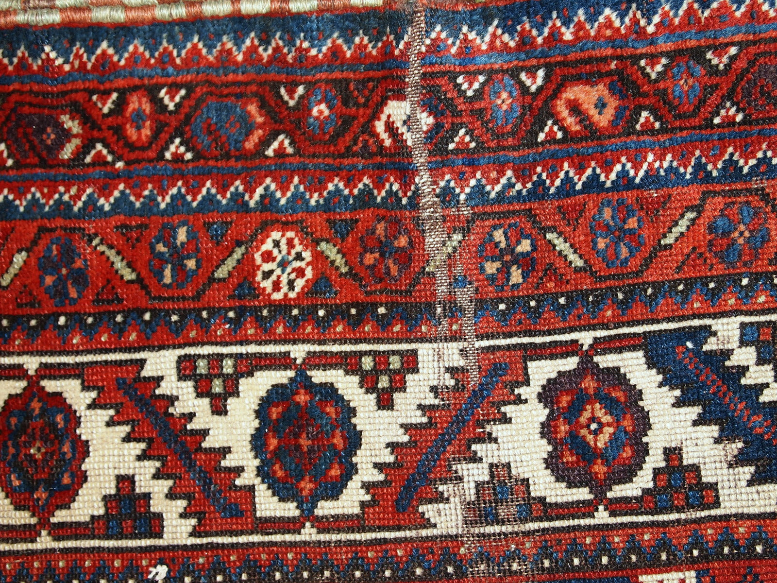 Antique Persian Shiraz rug in distressed condition. The rug made in traditional tribal design in the beginning of 20th century.