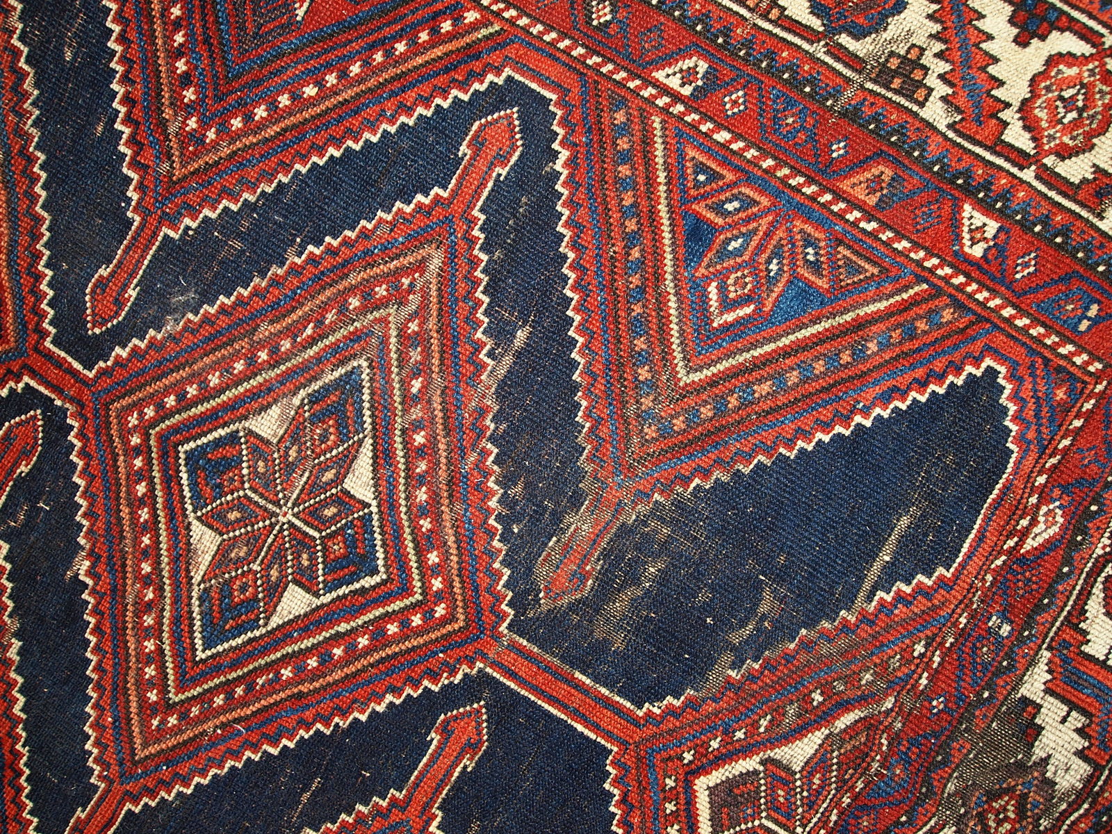 Antique Persian Shiraz rug in distressed condition. The rug made in traditional tribal design in the beginning of 20th century.
