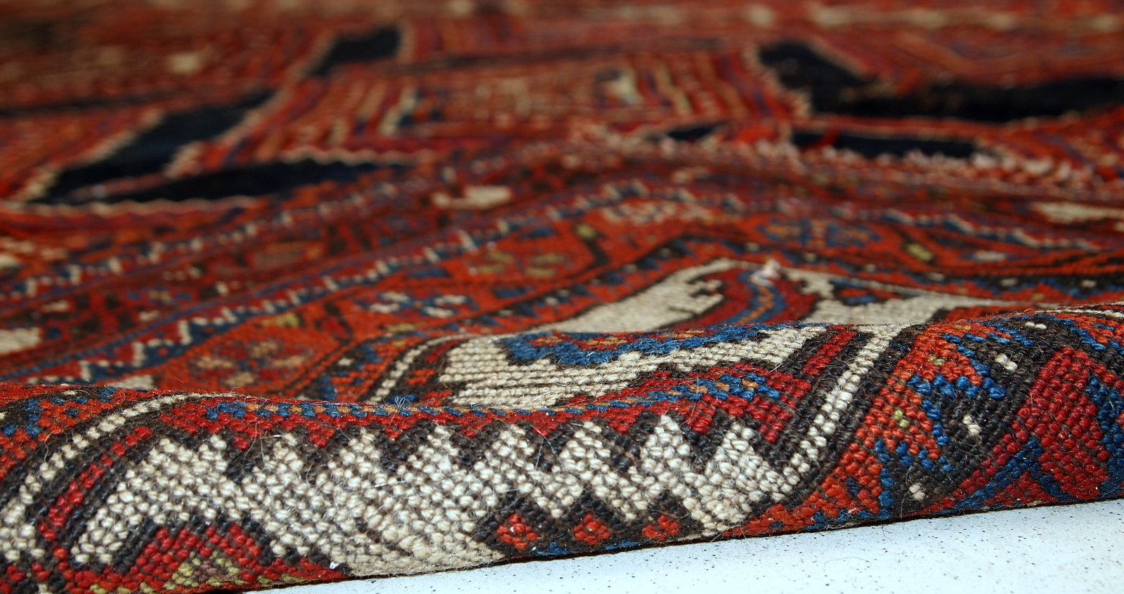 Handmade antique distressed Persian Shiraz rug, 1900s