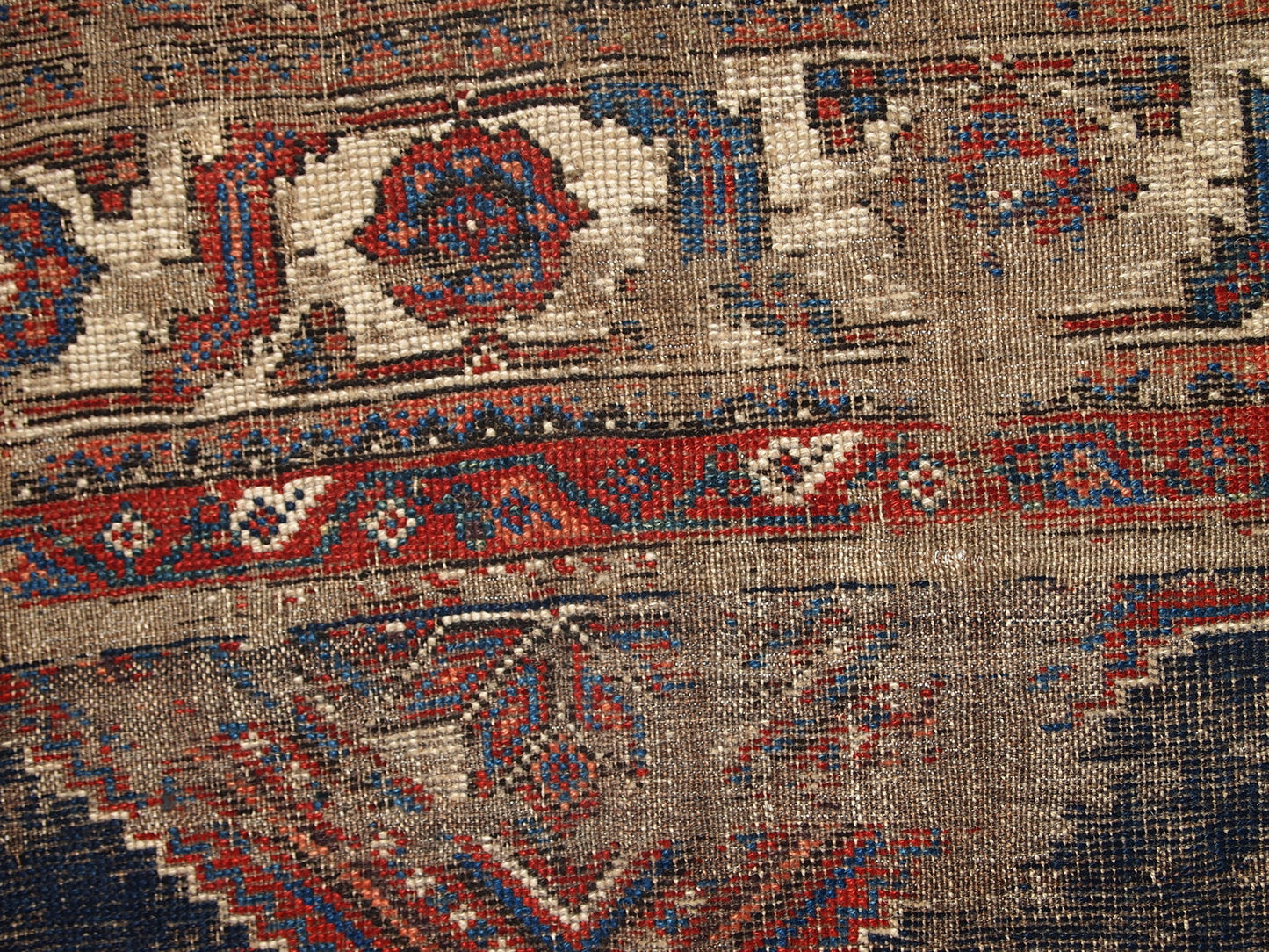 Antique Persian Shiraz rug in distressed condition. The rug made in traditional tribal design in the beginning of 20th century.