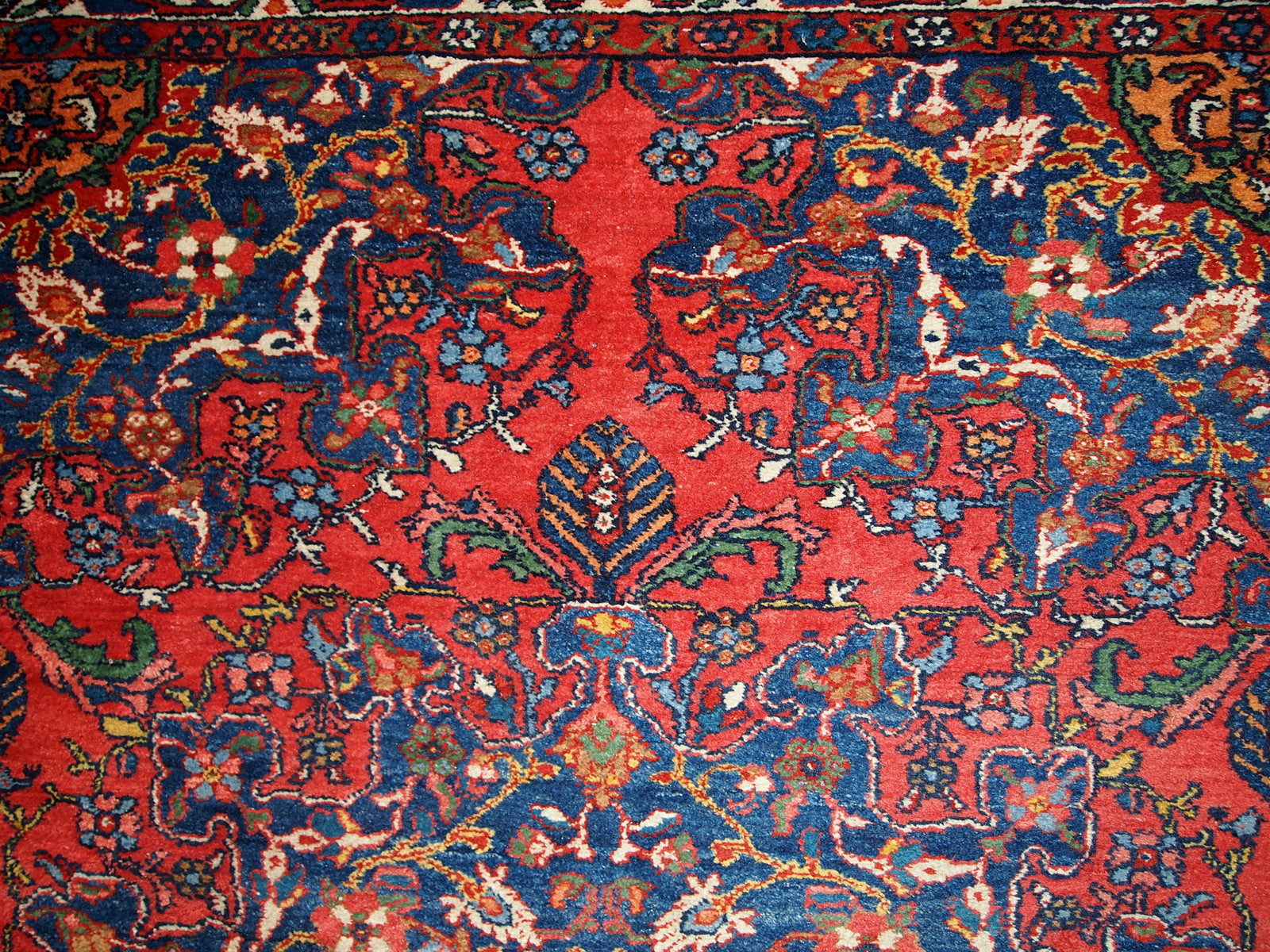 Vintage Persian Mashad rug in original good condition. It has been hand-weaved in the end of 20th century in wool.