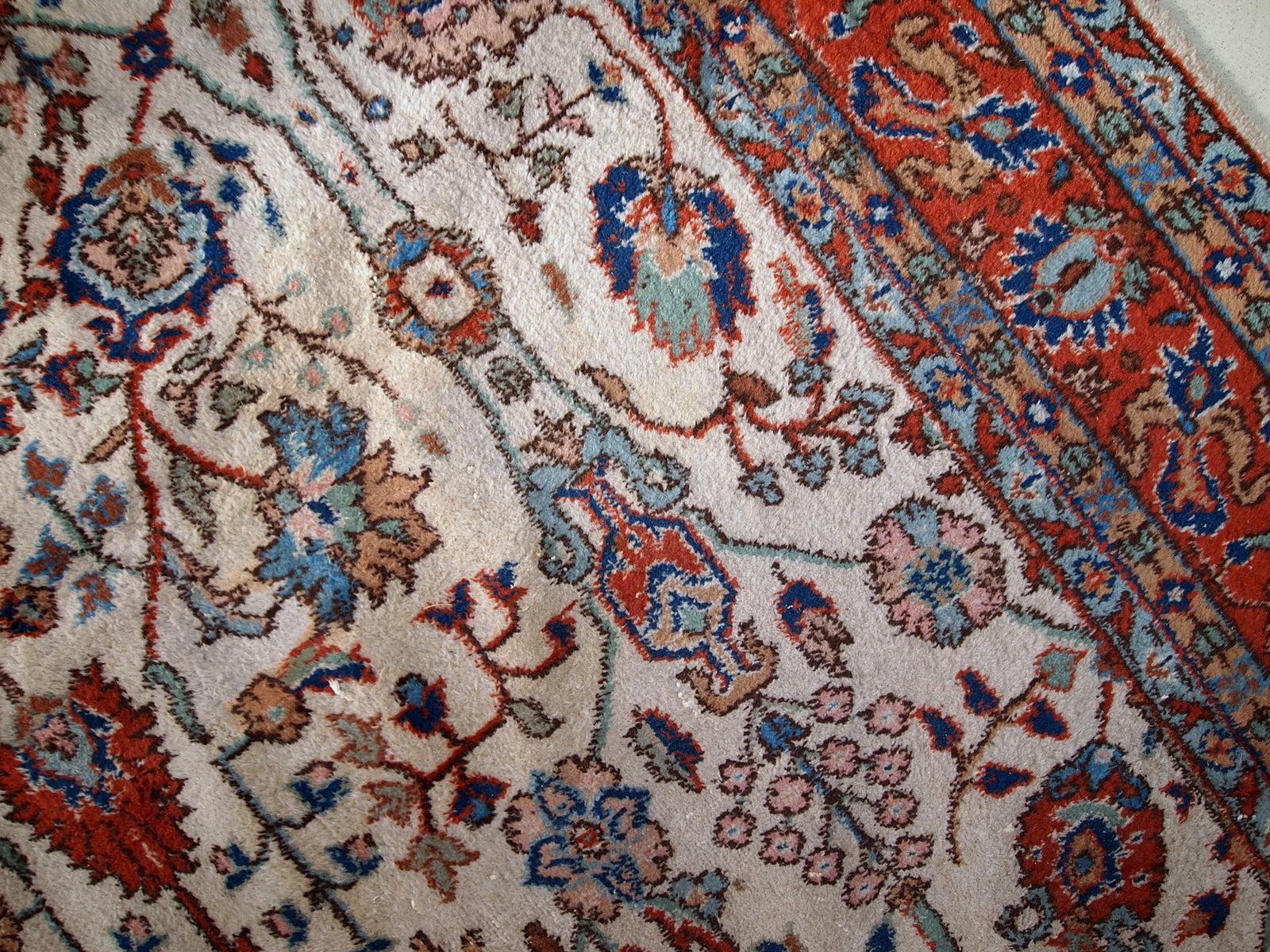 Handmade vintage Persian Mashad rug in beige shades and original good condition. Beautiful all-over design with garden accent is in blue and red colors.