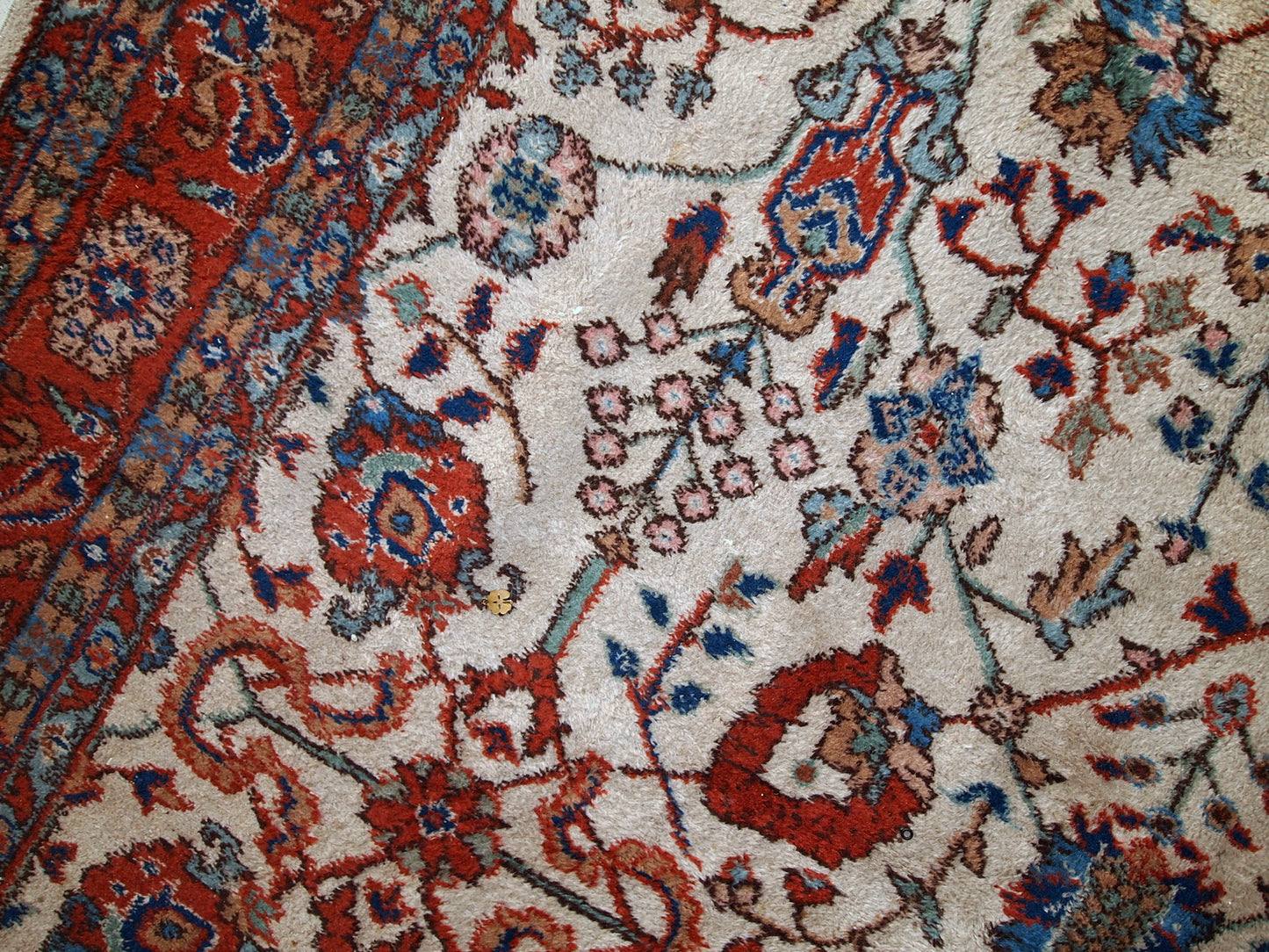 Handmade vintage Persian Mashad rug in beige shades and original good condition. Beautiful all-over design with garden accent is in blue and red colors.