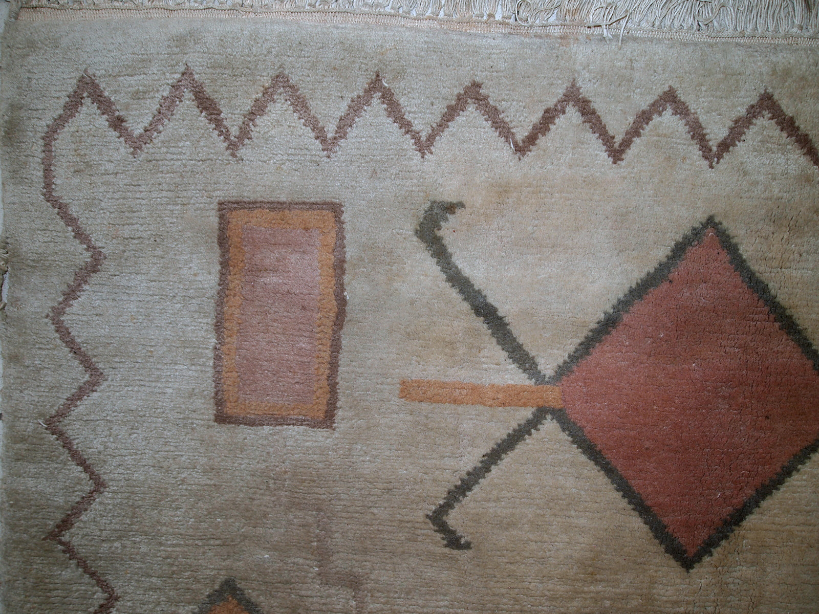 Handmade vintage Tibetan Khaden rug in original good condition. The rug has full pile, made in geometric design in beige shade. The rug is heavy.