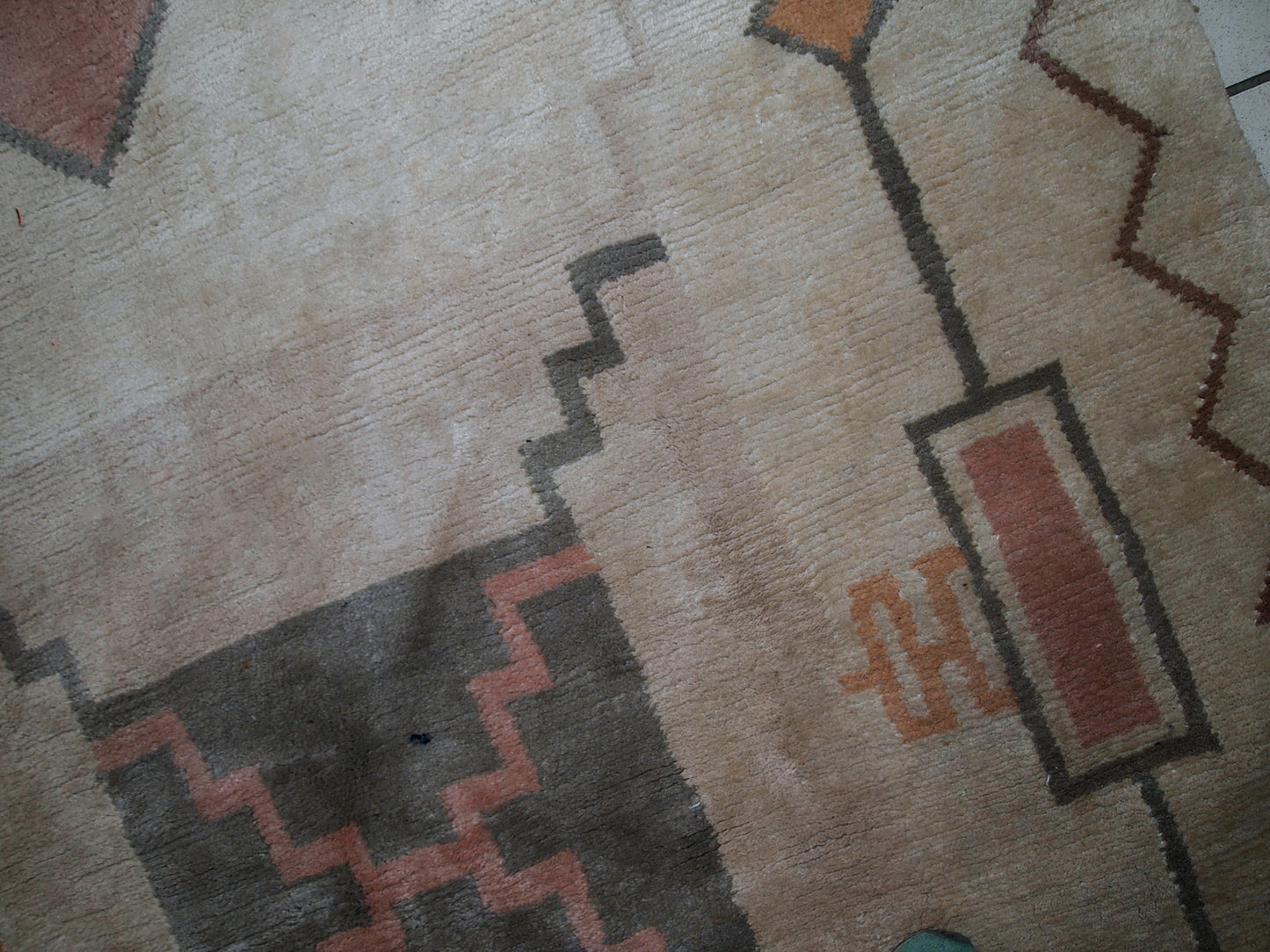 Handmade vintage Tibetan Khaden rug in original good condition. The rug has full pile, made in geometric design in beige shade. The rug is heavy.