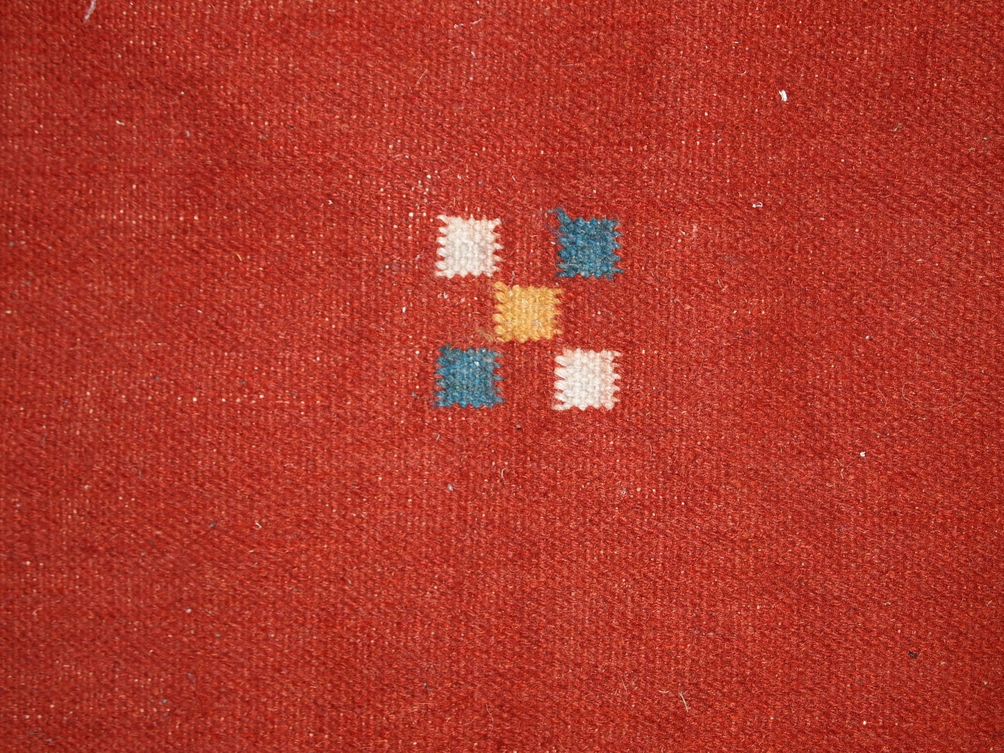 Mid-century Persian kilim in red shade and all-over design. Miniature animals are in navy blue shade along with border. Sky blue colors are in each corner. The kilim is generally in original good condition, one corner is missing.