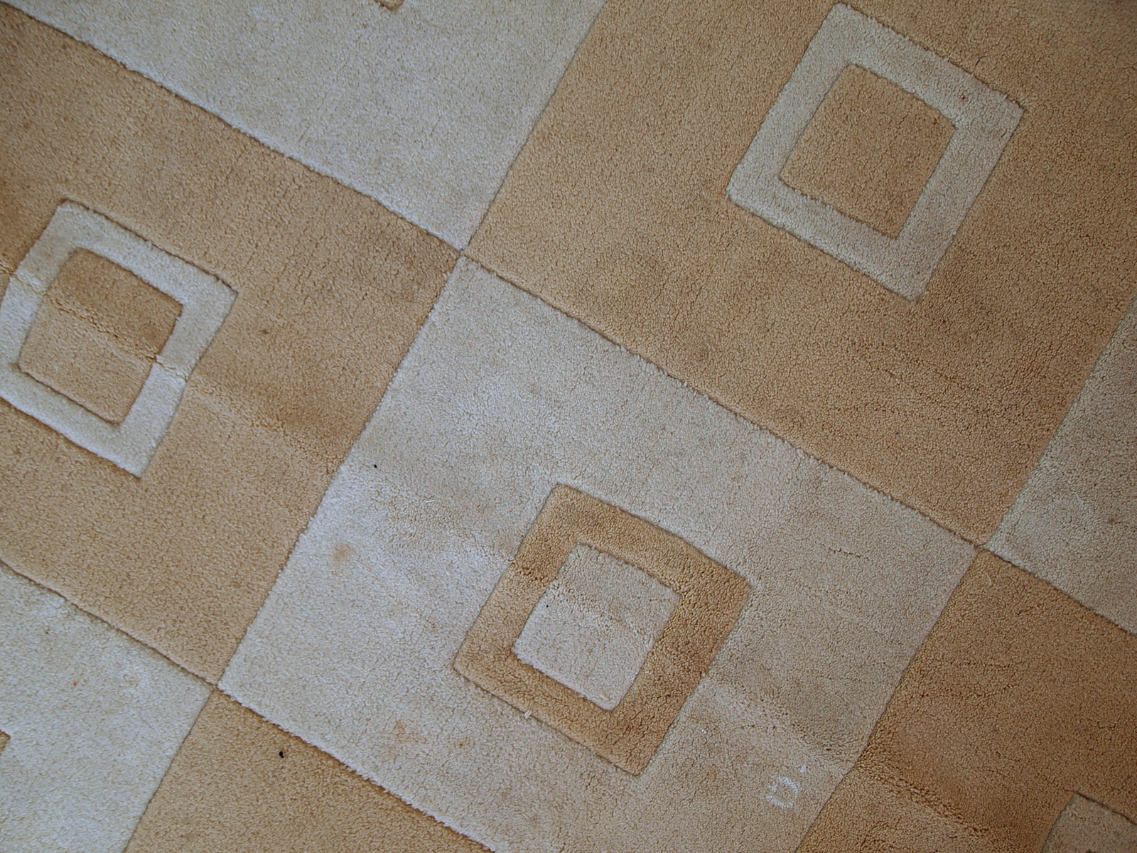 Handmade Chinese rug in light shades of white and brown. It has modern geometric design. The rug made out of acrylic in China. It is in original condition, has some age discolorations.