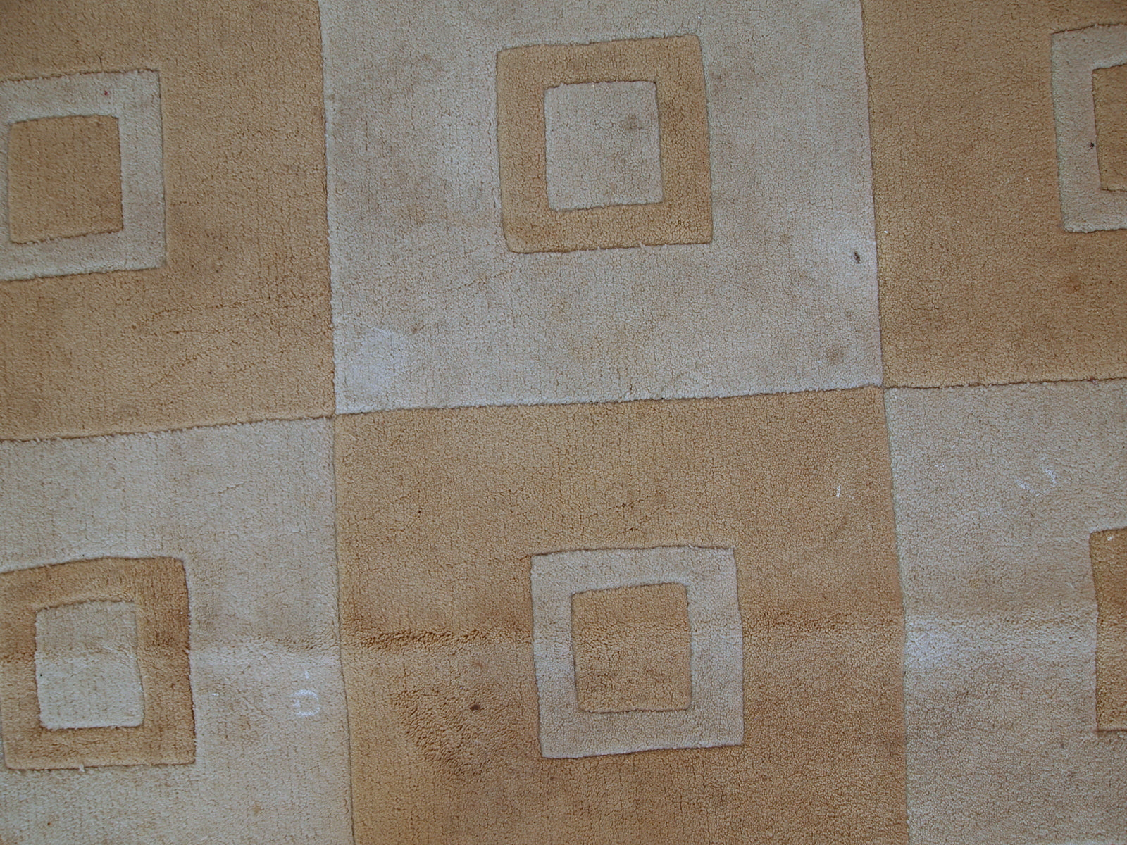 Handmade Chinese rug in light shades of white and brown. It has modern geometric design. The rug made out of acrylic in China. It is in original condition, has some age discolorations.