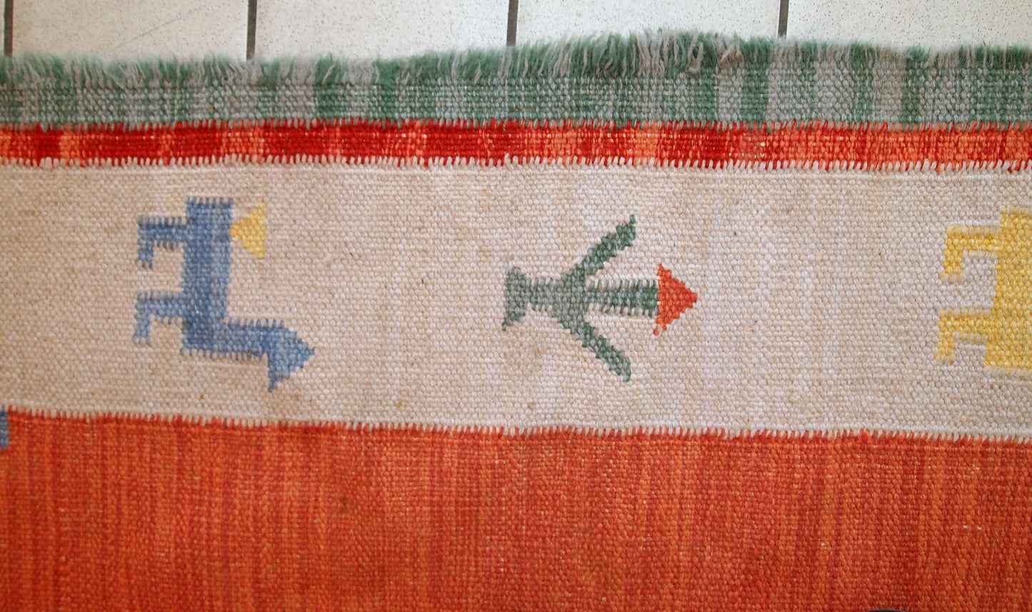 Vintage Persian kilim in bright shades of red, sky blue, beige and yellow. One side of the kilim has some age wear, but generally it is in original good condition.