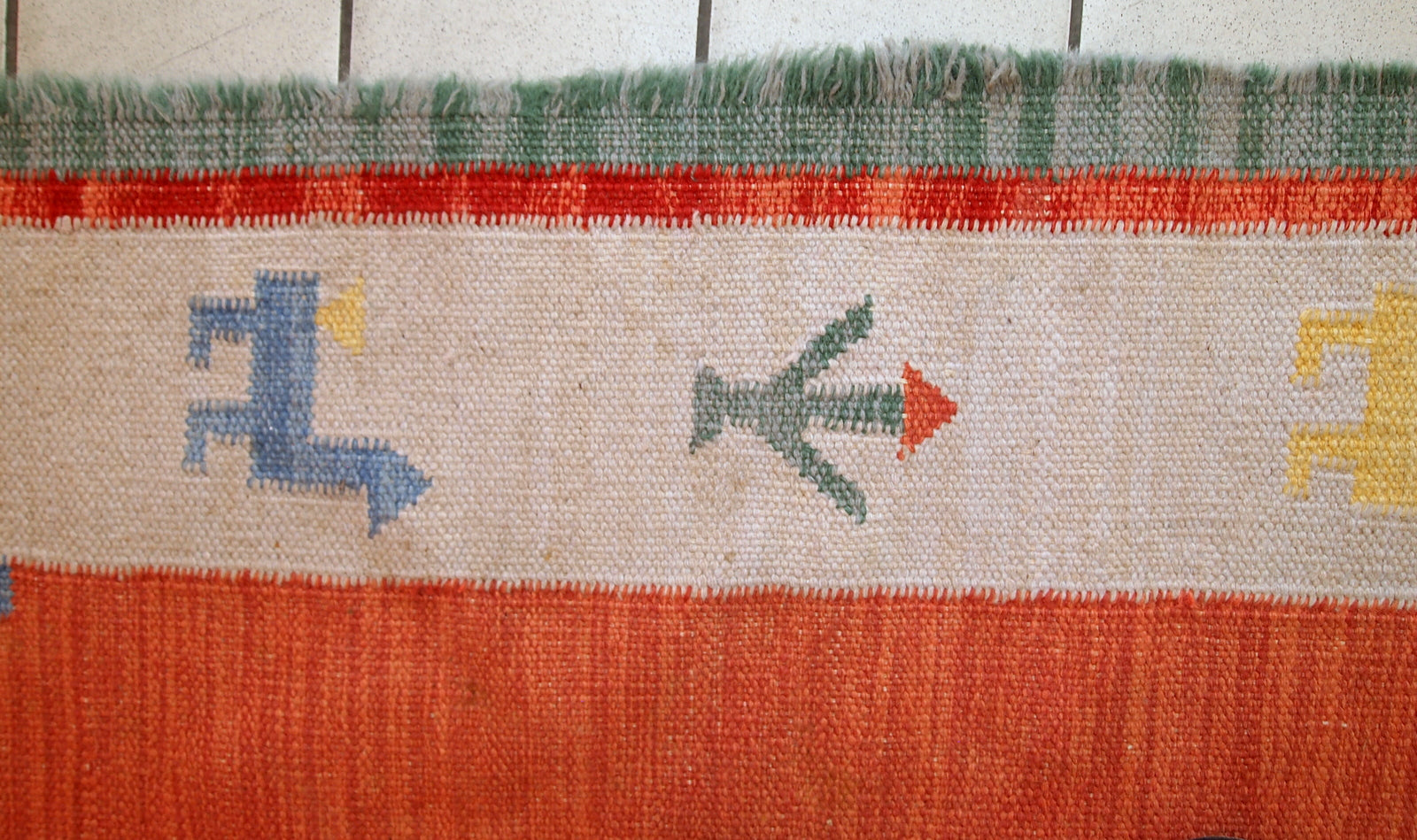 Vintage Persian kilim in bright shades of red, sky blue, beige and yellow. One side of the kilim has some age wear, but generally it is in original good condition.