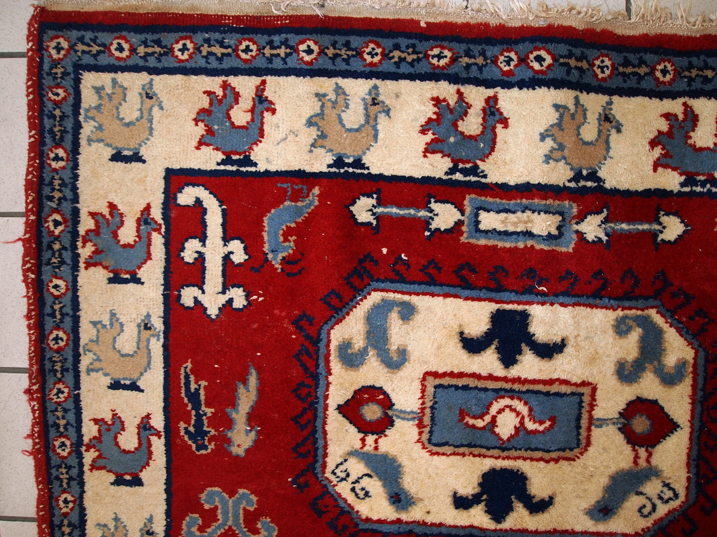 Handmade Russian vintage rug in deep red shade. The beige border decorated in roosters. Made out of wool, the rug is very thick and warm. It is in original good condition.