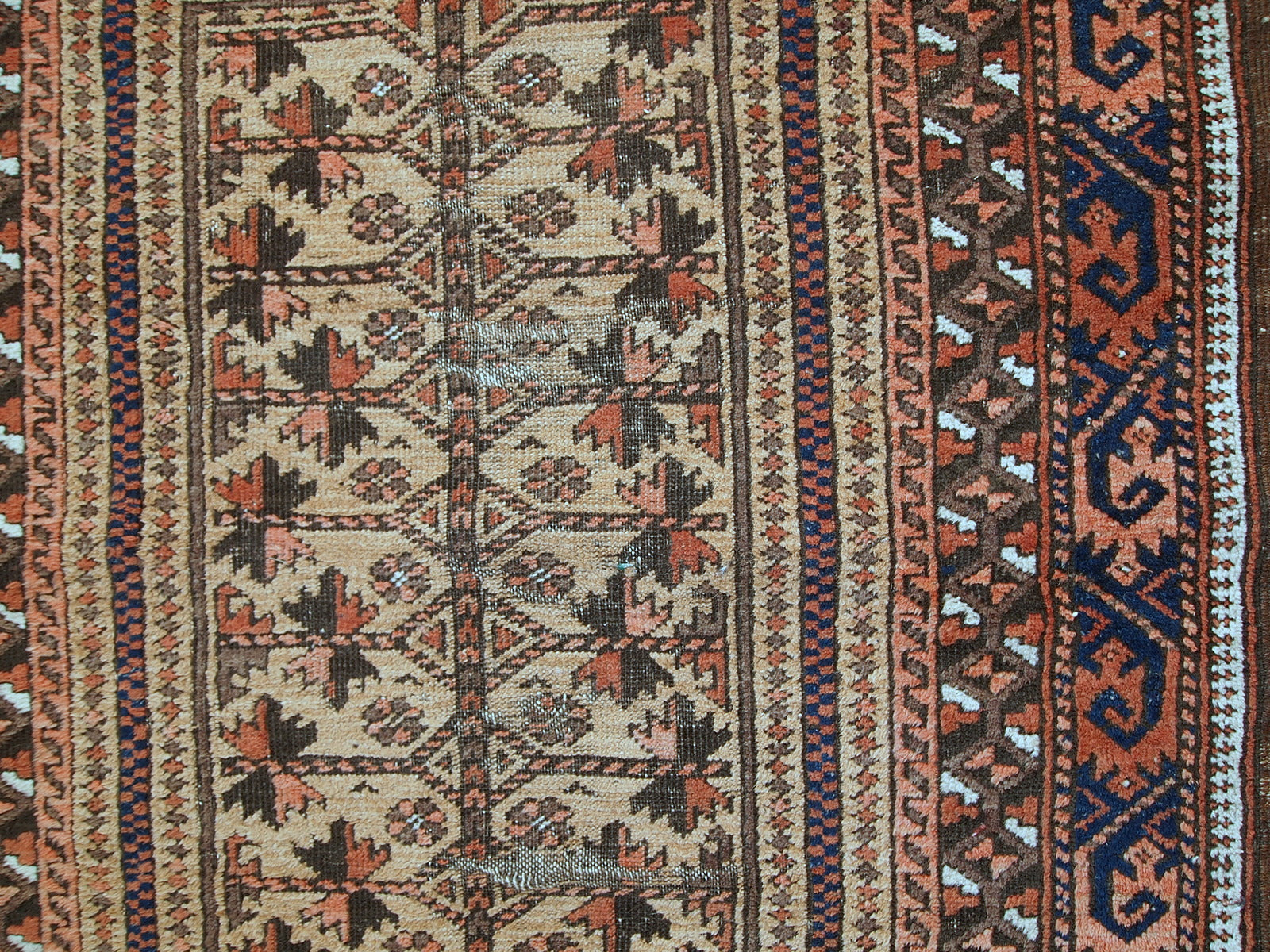 This prayer Baluch rug is in original condition, it has some little age wear and old restoration from the back. Light shade of brown on the field and red decorations. The border has beautiful tribal design in navy blue, pink and red. 