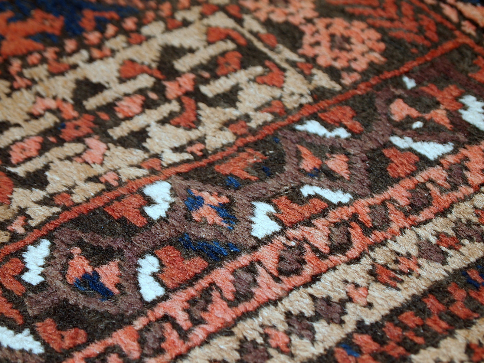 This prayer Baluch rug is in original condition, it has some little age wear and old restoration from the back. Light shade of brown on the field and red decorations. The border has beautiful tribal design in navy blue, pink and red. 