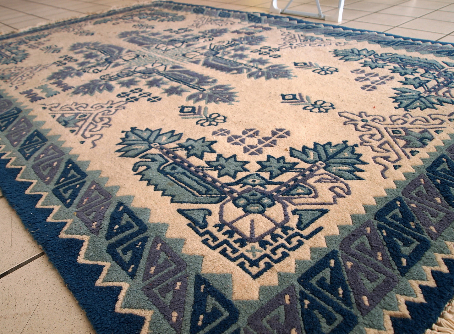Vintage Tunisian handmade rug in blue and white shades. The rug is from the middle of 20th century, made out of wool. It is in tribal design and in original good condition.