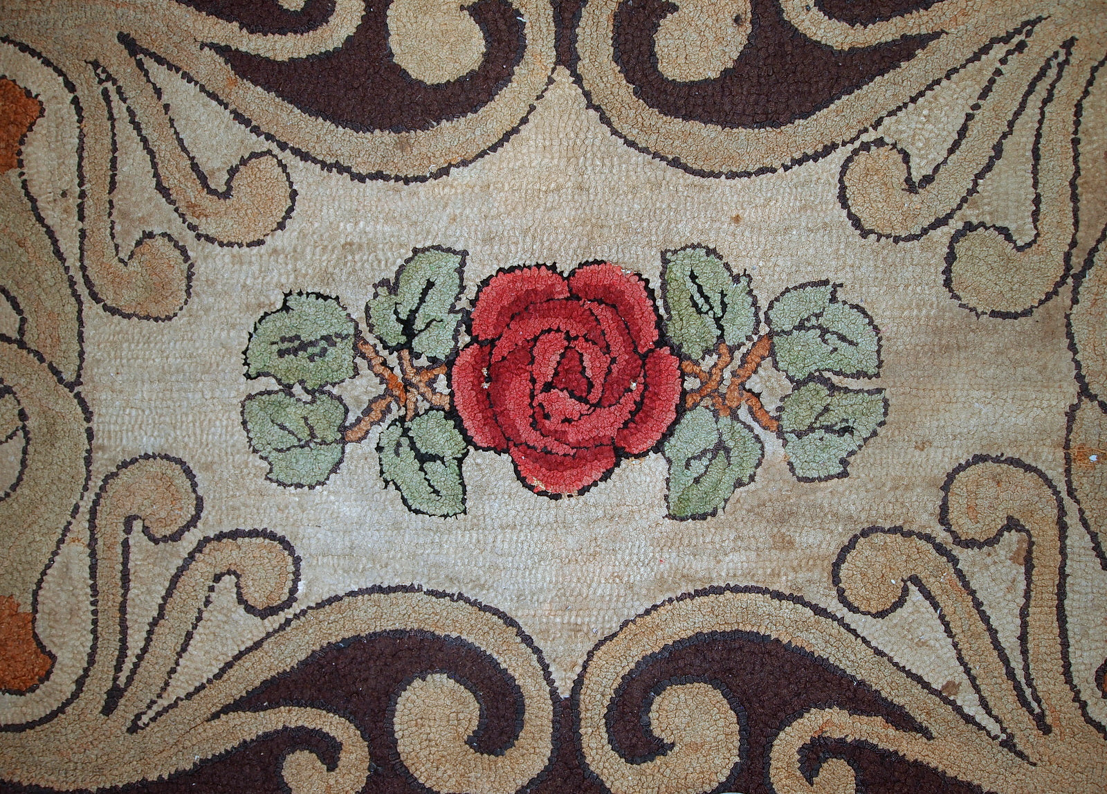 Antique American primitive hooked rug in floral design. The rug has been restored but it has some age discolorations on the light background. 