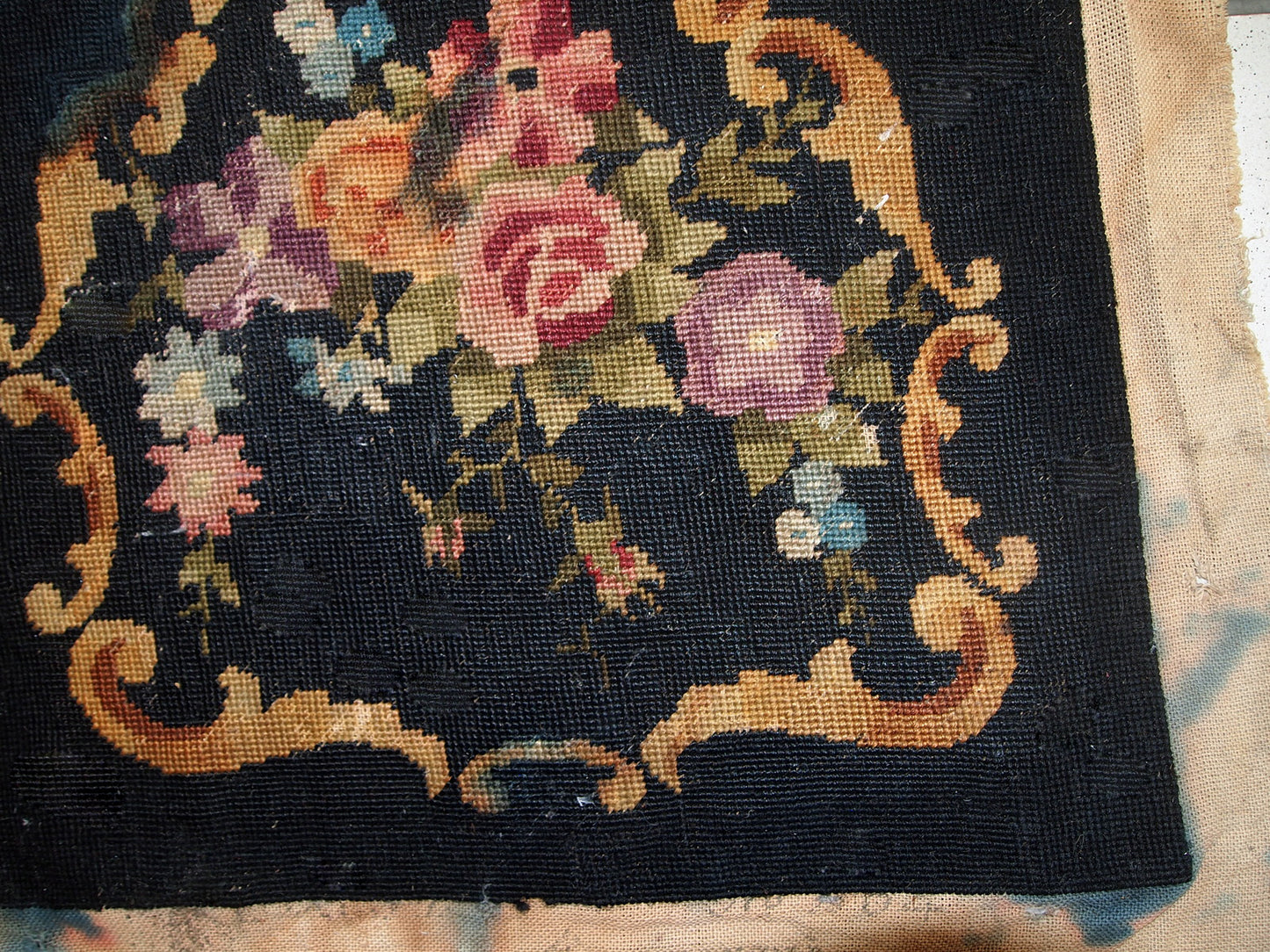Handmade antique unframed English Needlepoint in black colour with floral design. The size of actual needlepoint is 1.3' x 1.4' (42cm x 45cm) and with the sides is 2' x 2.2' (63cm x 68cm). It is in original condition, it has some discolourations on the side areas. It can be framed or attached to a decorative pillow, chair etc.