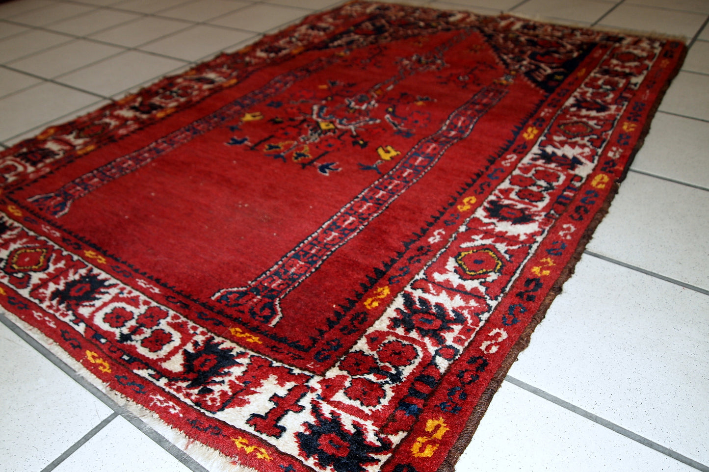 Vintage handmade Turkish prayer rug in bright red shade with yellow, white and navy blue details. The rug is in original condition, it has some low pile. Made out of soft wool. 