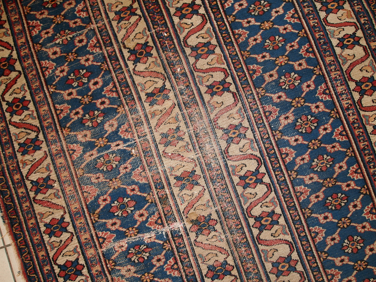 Handmade antique Persian Mashad runner in original condition. All-over design, split in two parts. The shade of blue is changing from one side to another from darker to lighter. It is in distressed condition.
