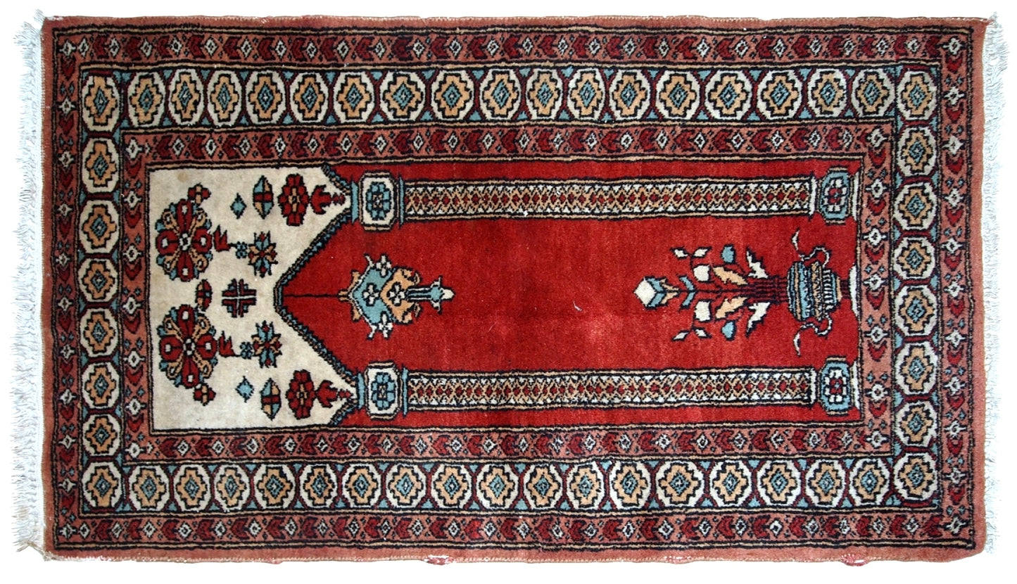 Handmade vintage prayer Pakistani Lahore rug in original good condition. The rug is in bright shade of red and beautiful decorative border.