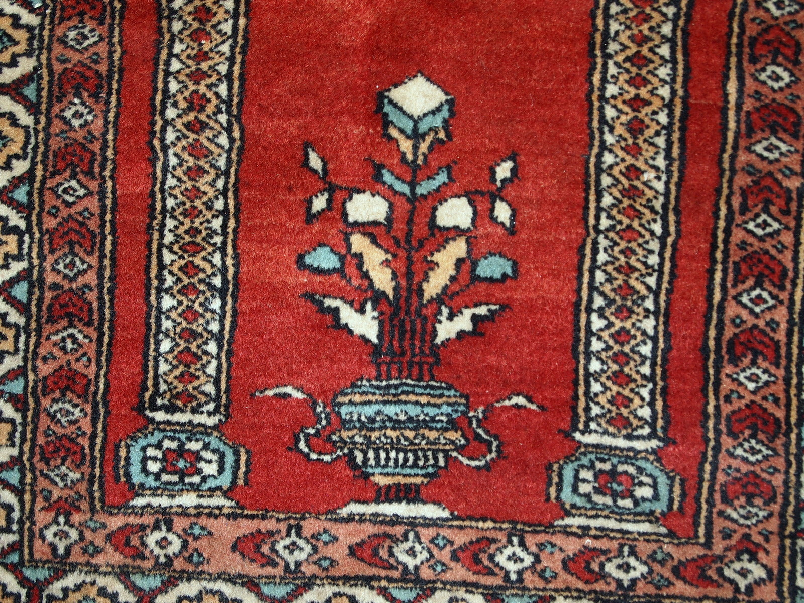 Handmade vintage prayer Pakistani Lahore rug in original good condition. The rug is in bright shade of red and beautiful decorative border.