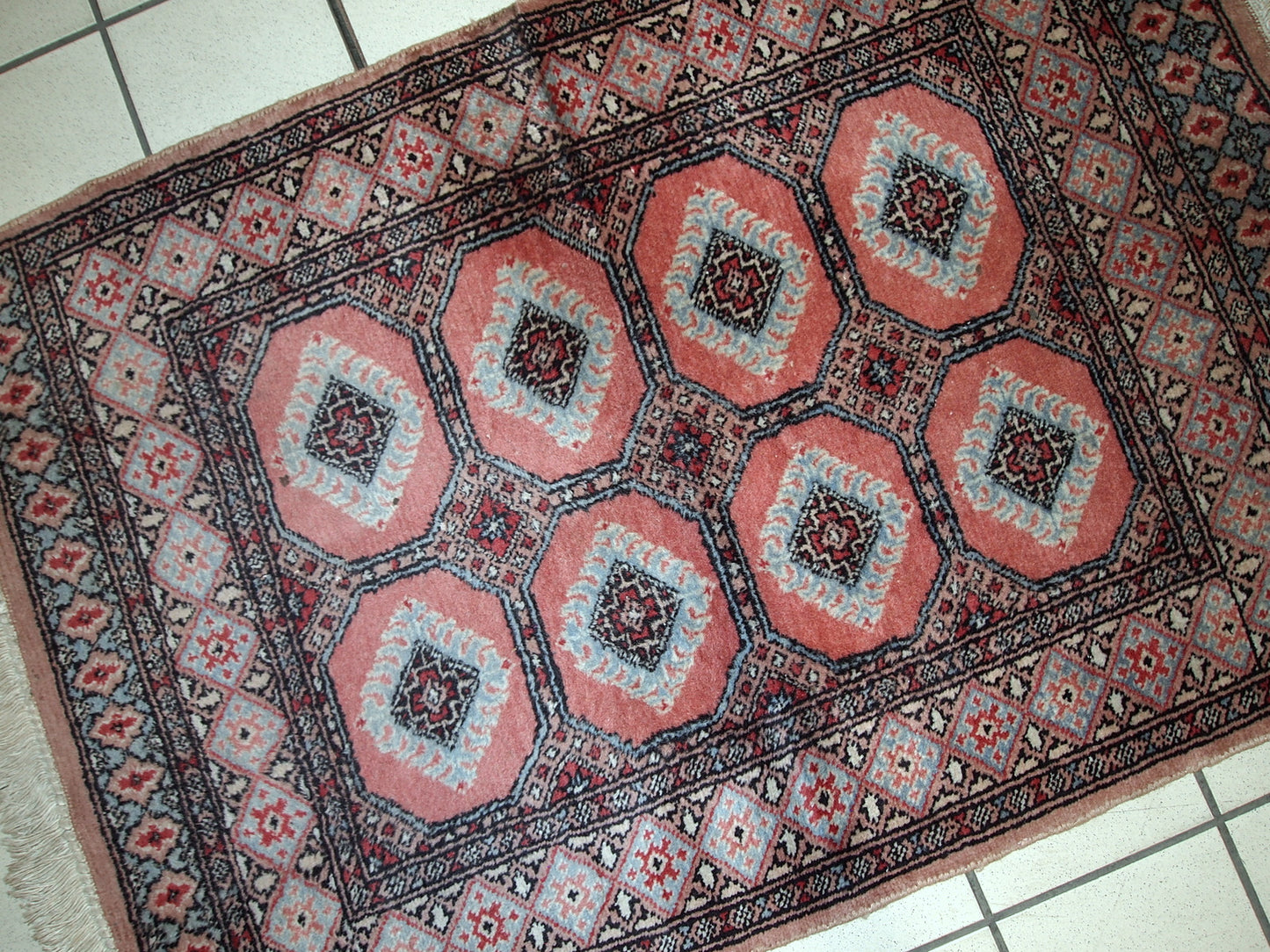 Handmade vintage Uzbek rug in pink and sky blue wool. It has been made in the middle of 20th century in Central Asia.