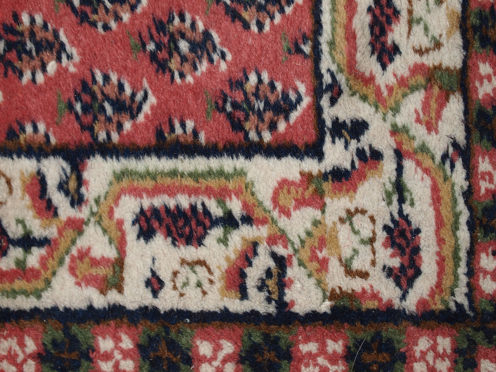 Handmade vintage small rug from India in red color. It is in original good condition from the end of 20th century.