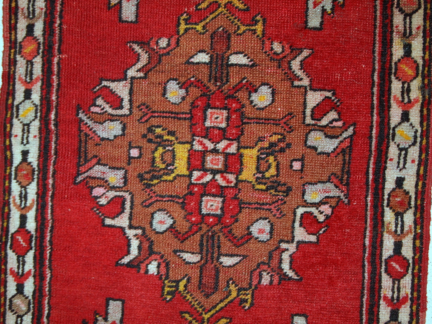 Handmade vintage Turkish Yastik rug in bright red colour. The rug is in original good condition from the middle of 20th century.