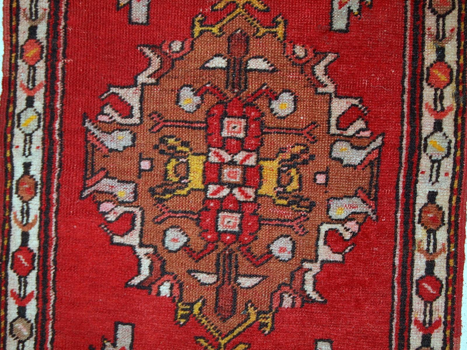Handmade vintage Turkish Yastik rug in bright red colour. The rug is in original good condition from the middle of 20th century.