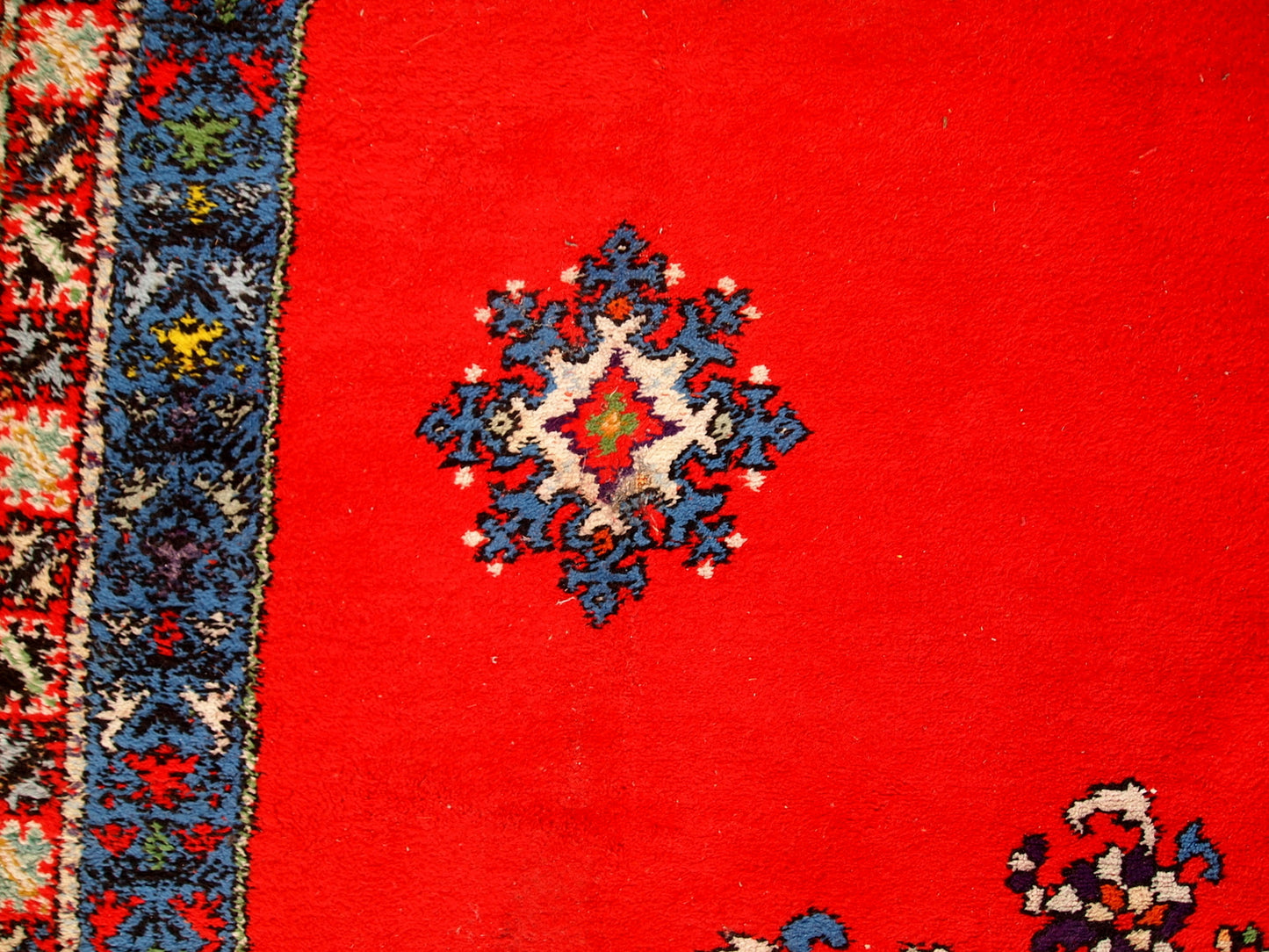 Handmade vintage rug from Berber in Morocco in flashy red wool. The rug is from the end of 20th century in original good condition.