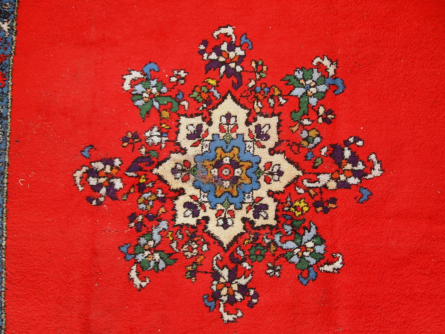 Handmade vintage rug from Berber in Morocco in flashy red wool. The rug is from the end of 20th century in original good condition.
