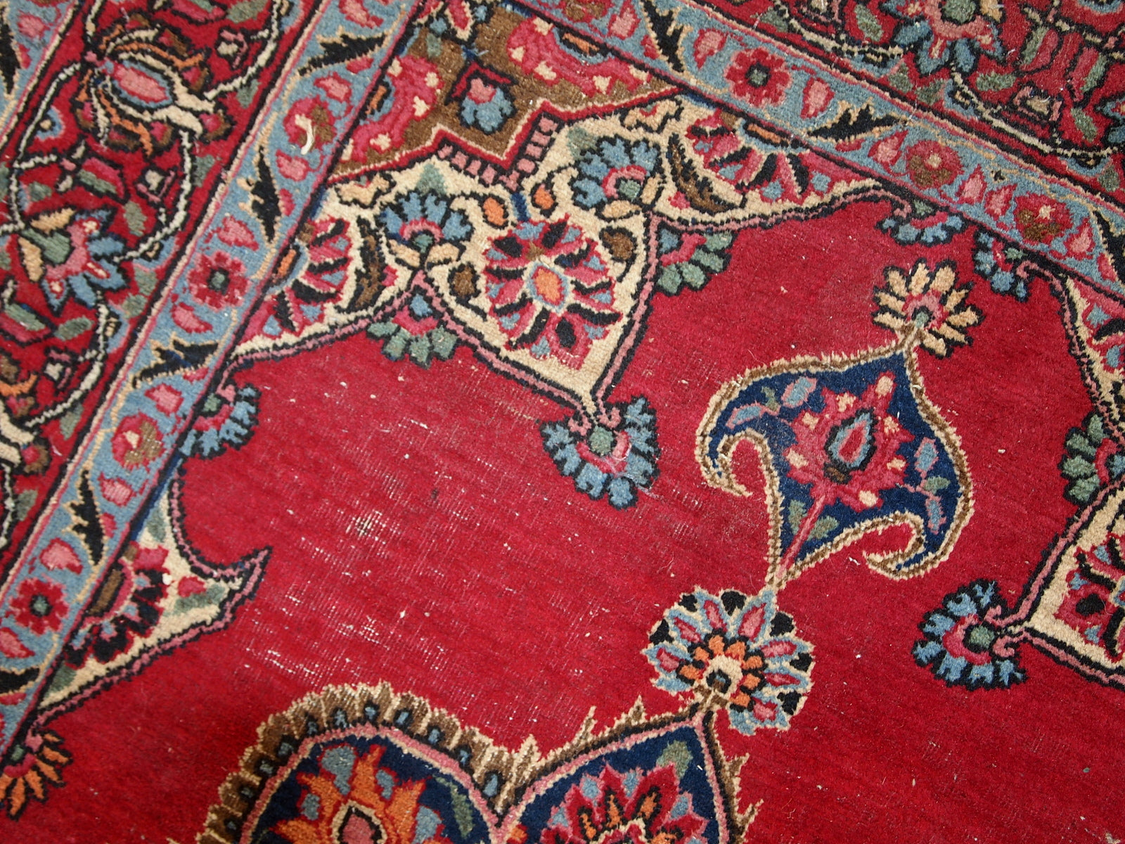 Vintage Persian Kazvin rug in bright red color. The rug is from the end of 20th century. It is in original condition, has some low pile.