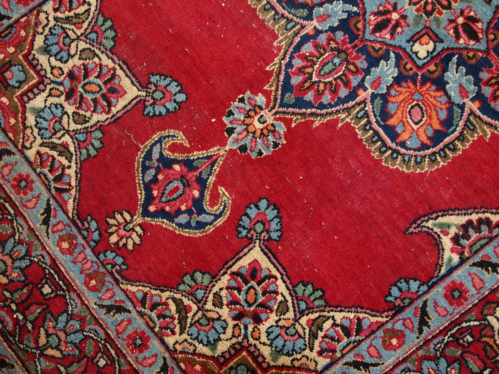 Vintage Persian Kazvin rug in bright red color. The rug is from the end of 20th century. It is in original condition, has some low pile.