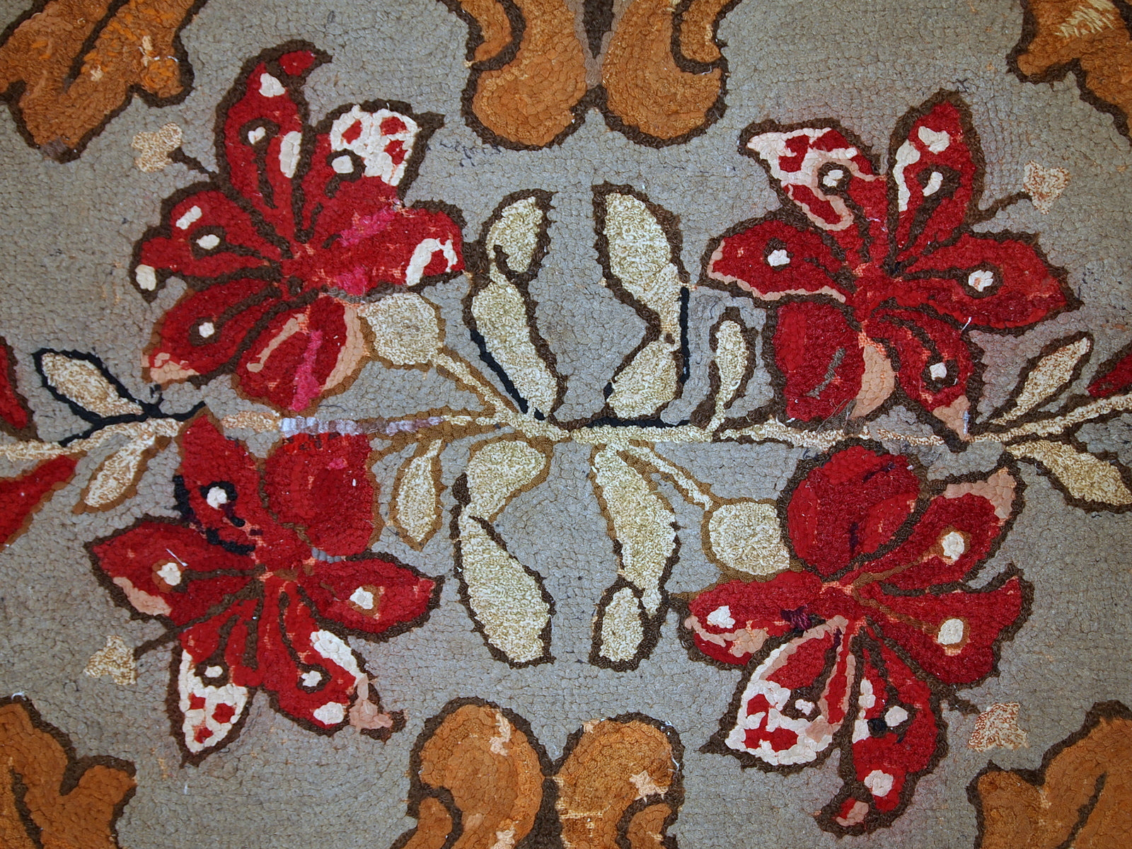 Handmade antique American Hooked rug in floral design. The rug has been made in the beginning of 20th century in USA. It is in original condition, has some signs of age.