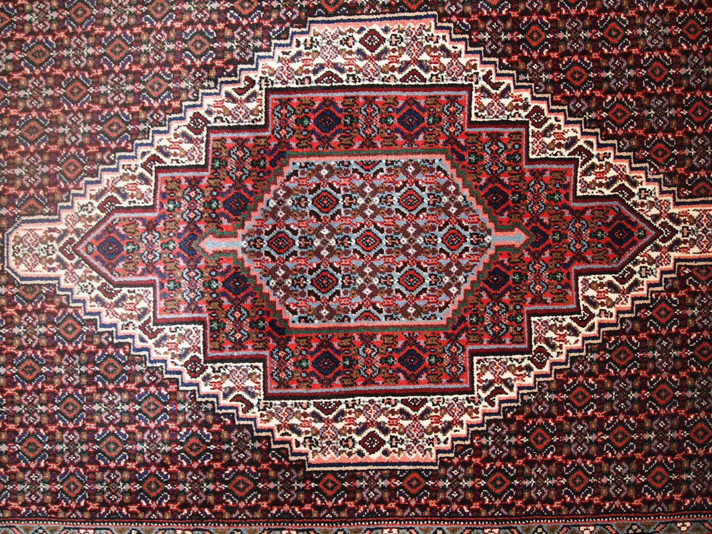Handmade vintage Nain rug in original good condition. The rug is from the end of 20th century made in wool.